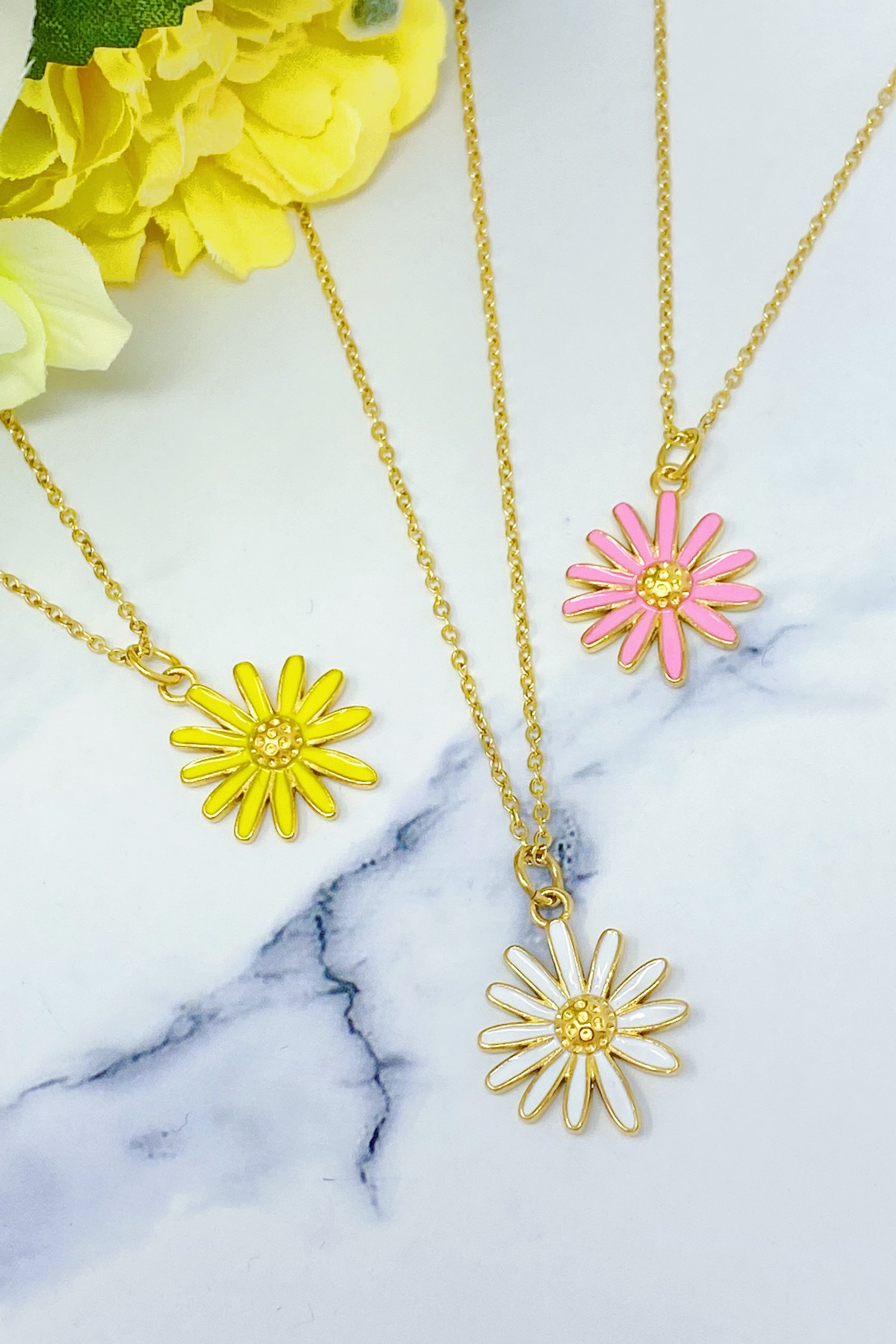 Sweet Daisy Necklace featuring a daisy pendant with CZ stones on a gold plated chain.