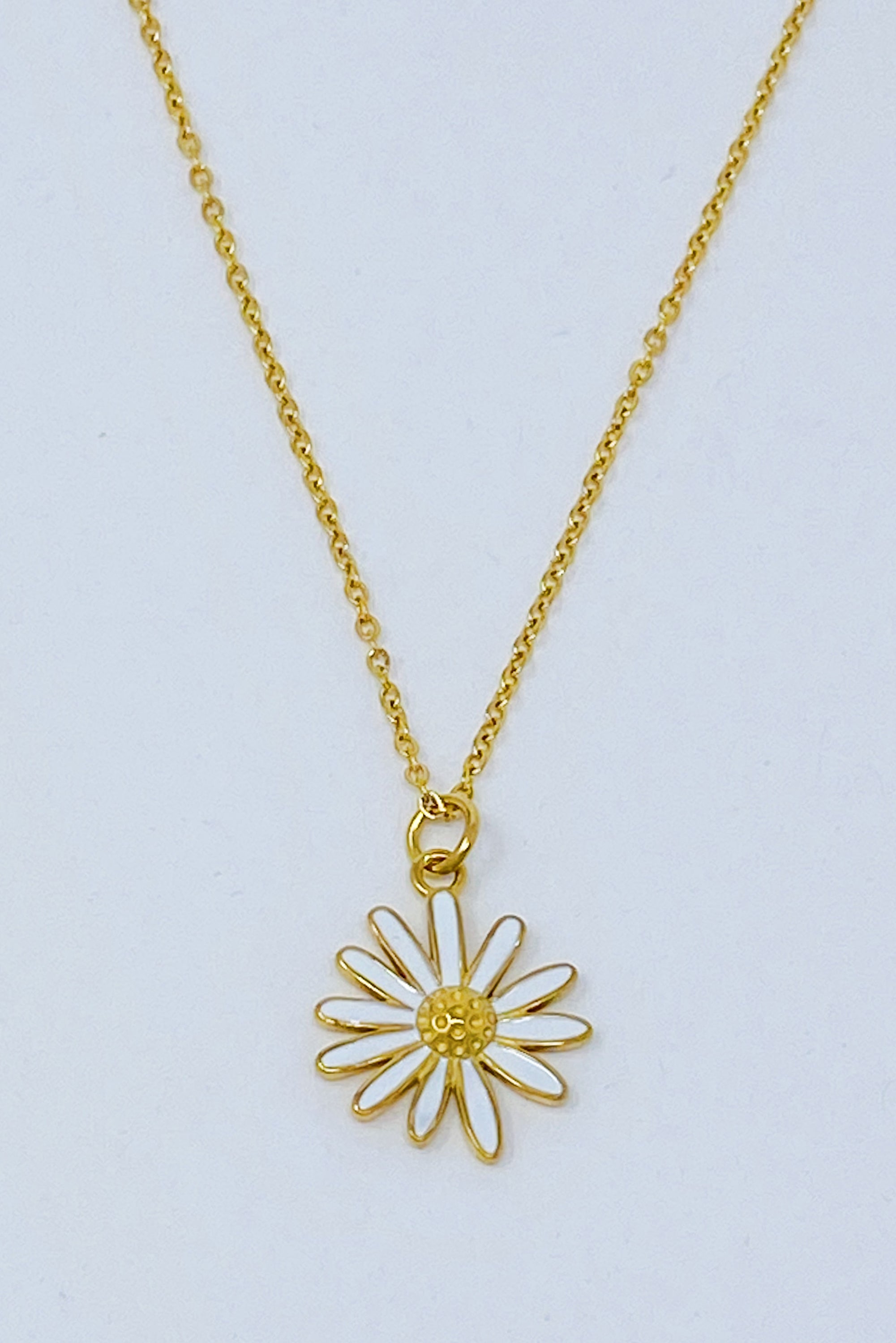 Sweet Daisy Necklace featuring a daisy pendant with CZ stones on a gold plated chain.