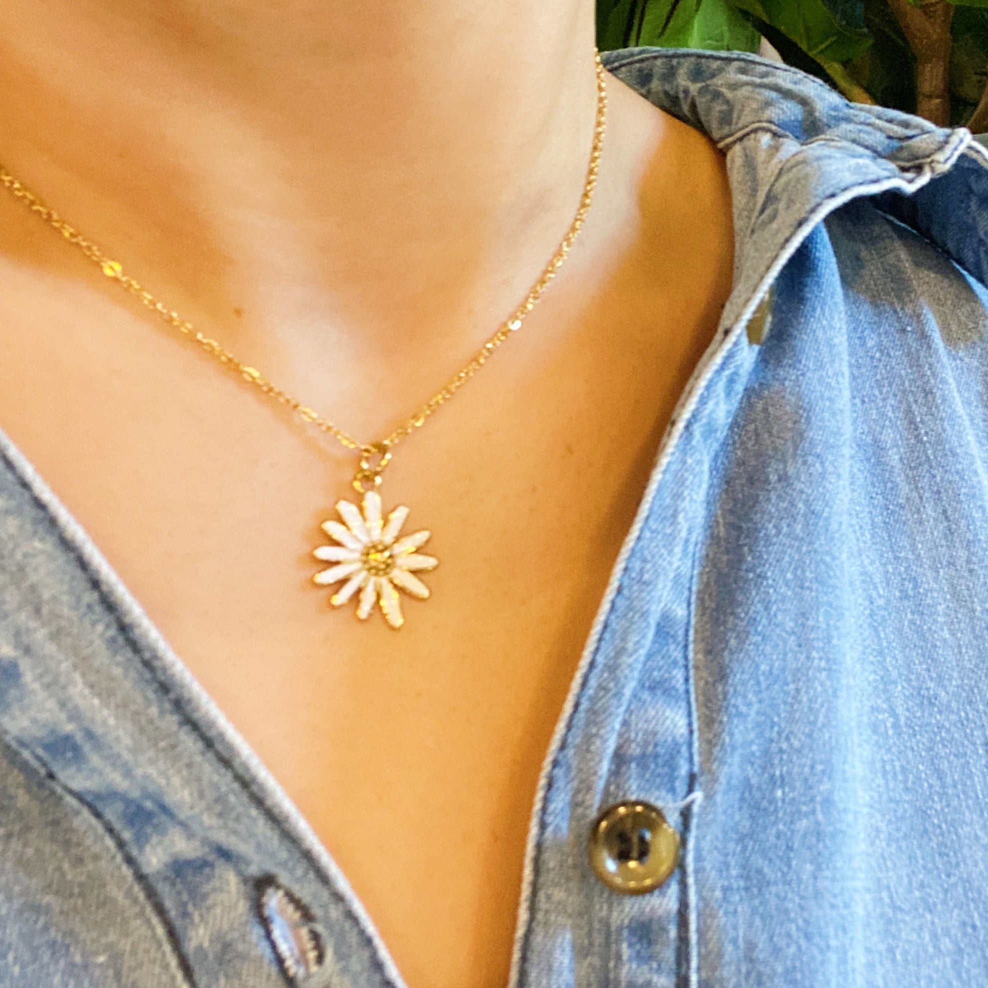 Sweet Daisy Necklace featuring a daisy pendant with CZ stones on a gold plated chain.