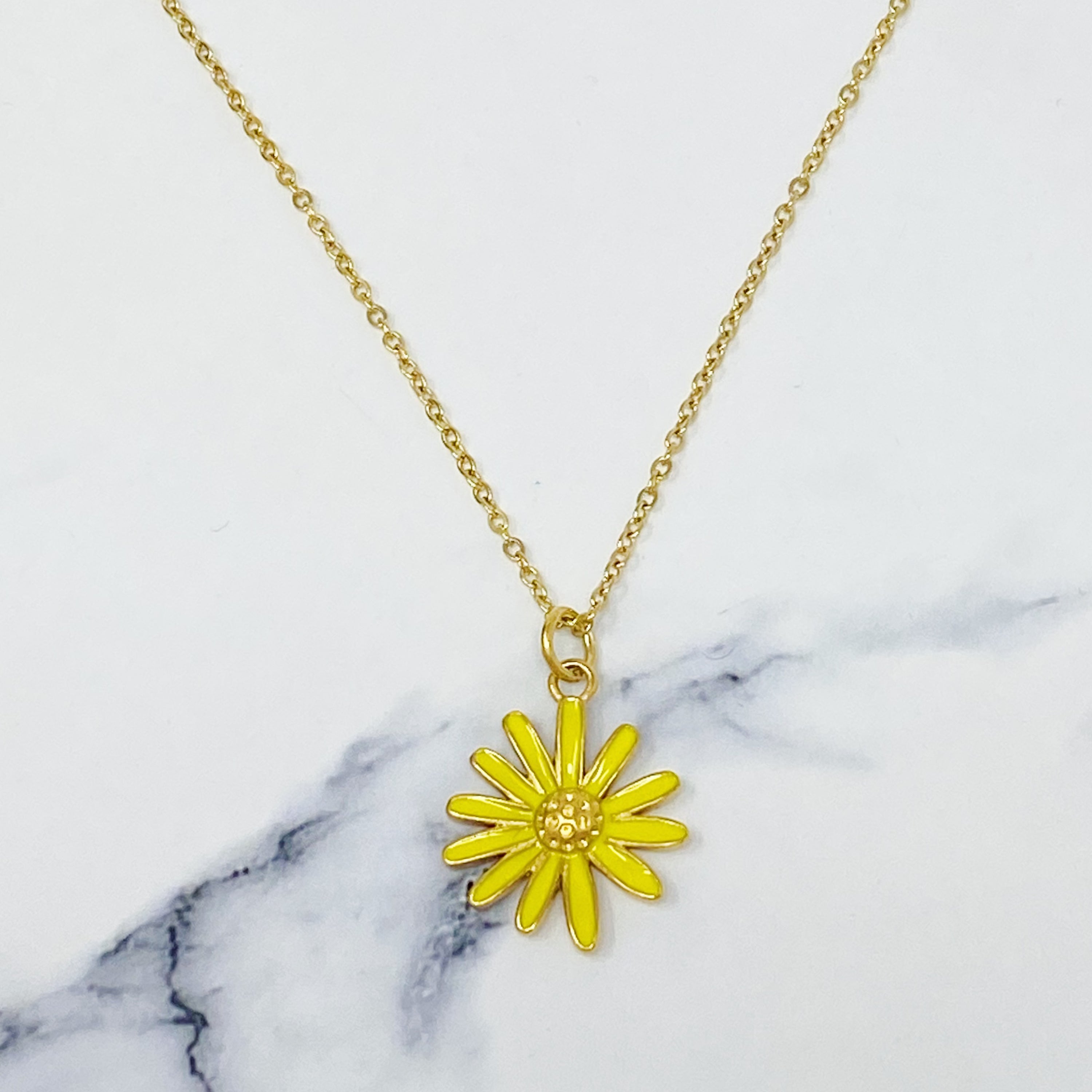 Sweet Daisy Necklace featuring a daisy pendant with CZ stones on a gold plated chain.