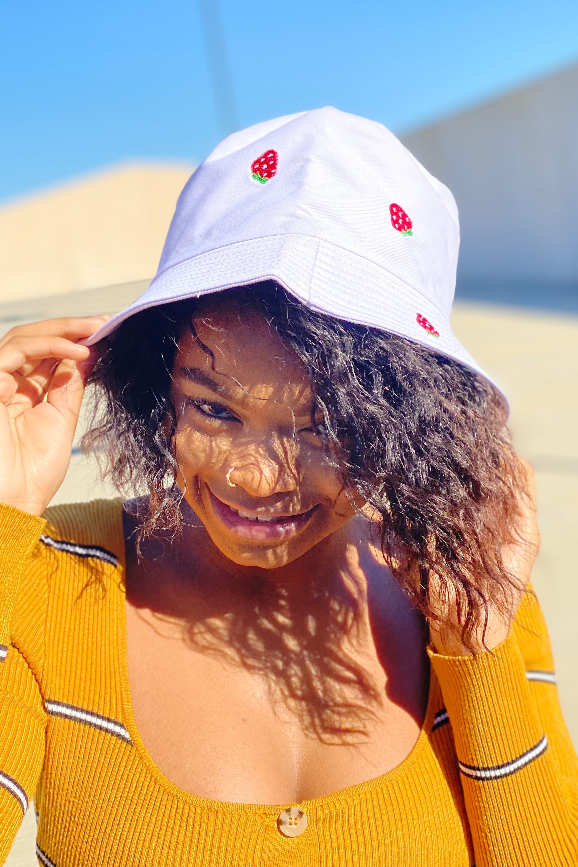 A stylish Sweety Fruity Bucket Hat featuring colorful embroidered fruit patterns on a high-quality cotton fabric, perfect for summer wear.