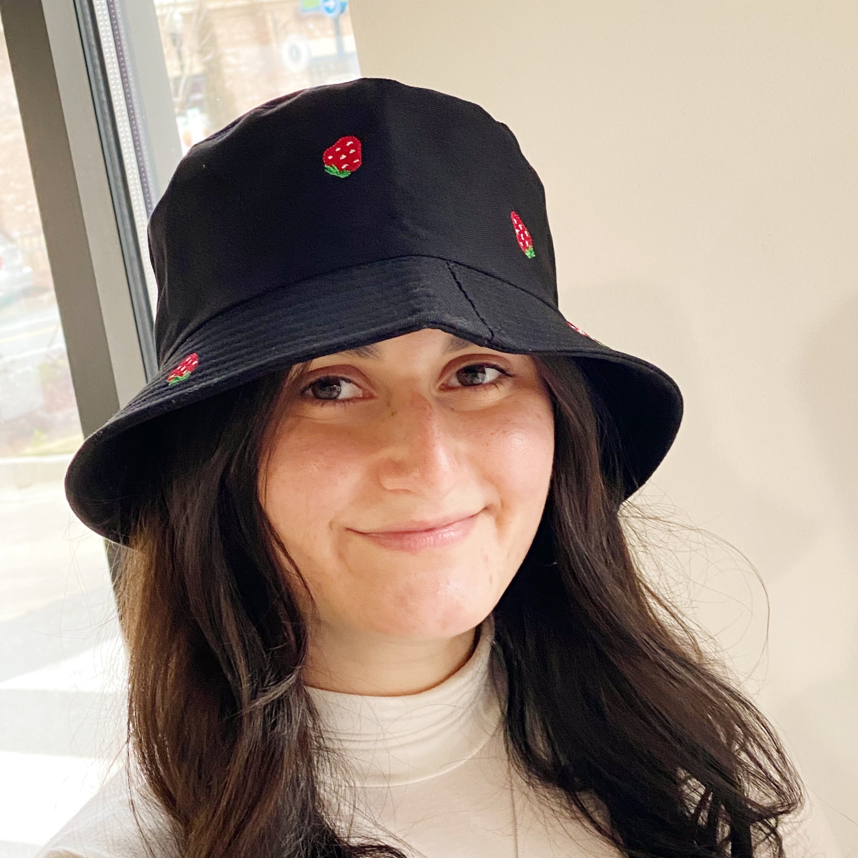 A stylish Sweety Fruity Bucket Hat featuring colorful embroidered fruit patterns on a high-quality cotton fabric, perfect for summer wear.