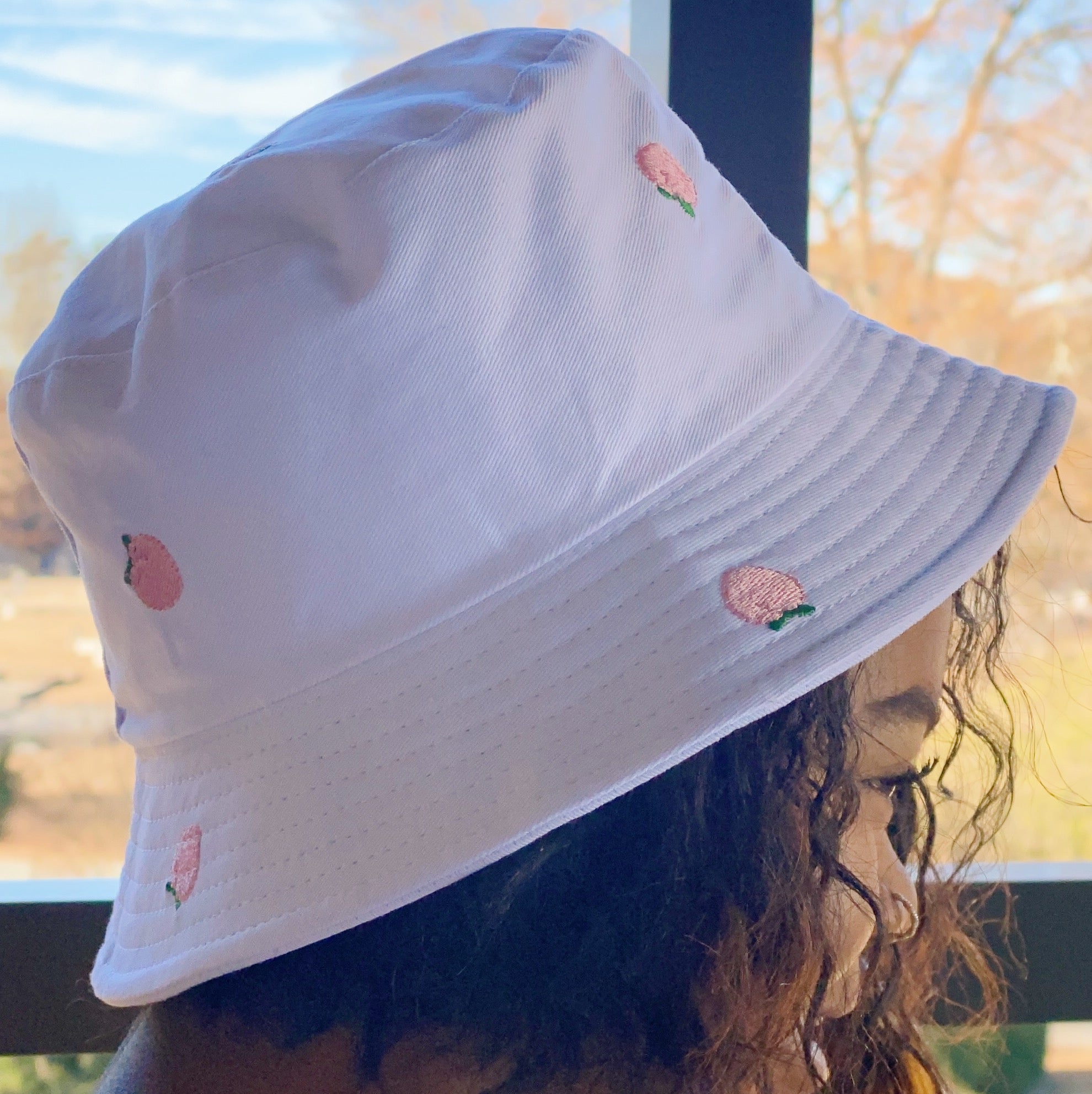 A stylish Sweety Fruity Bucket Hat featuring colorful embroidered fruit patterns on a high-quality cotton fabric, perfect for summer wear.