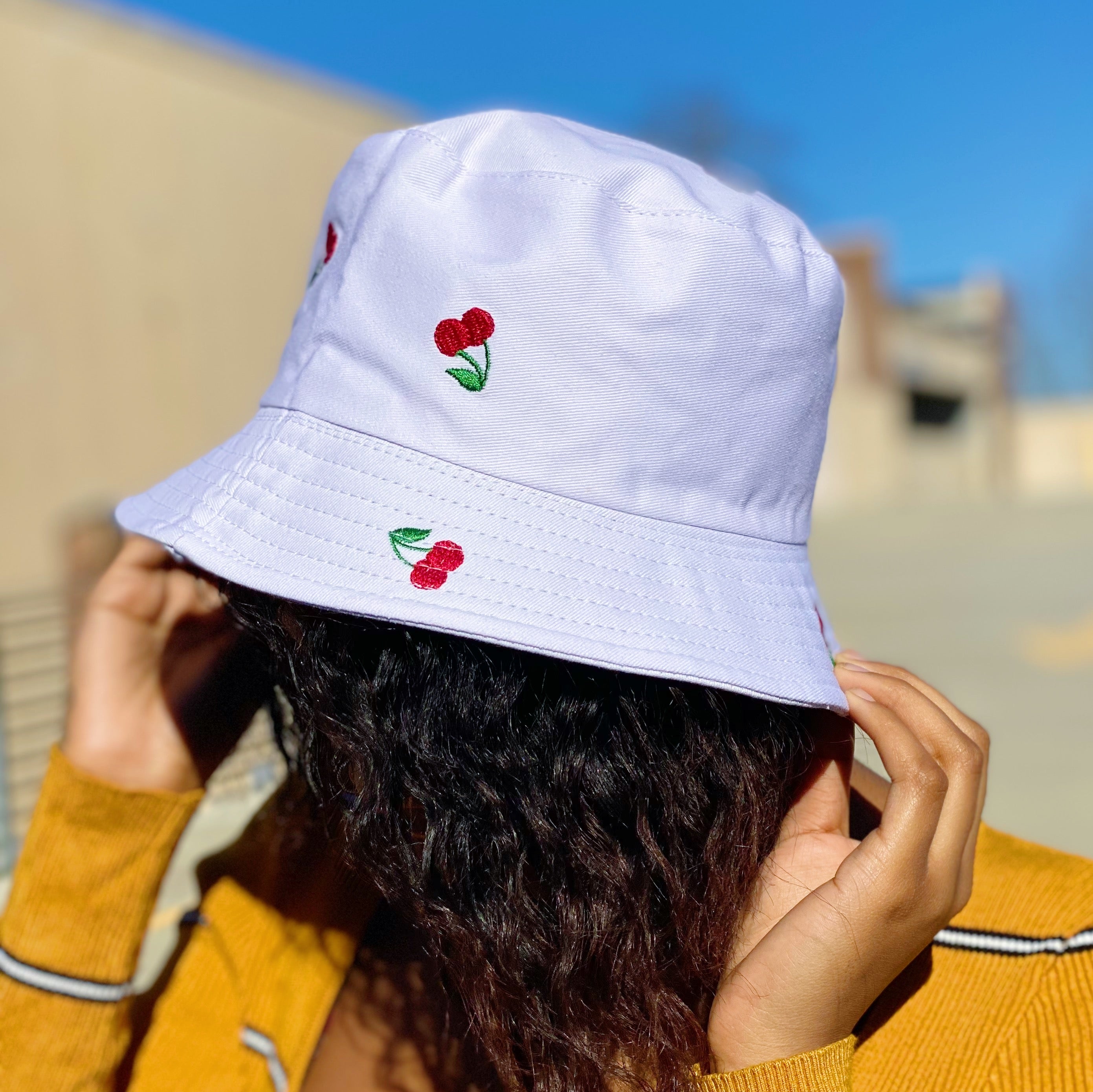 A stylish Sweety Fruity Bucket Hat featuring colorful embroidered fruit patterns on a high-quality cotton fabric, perfect for summer wear.