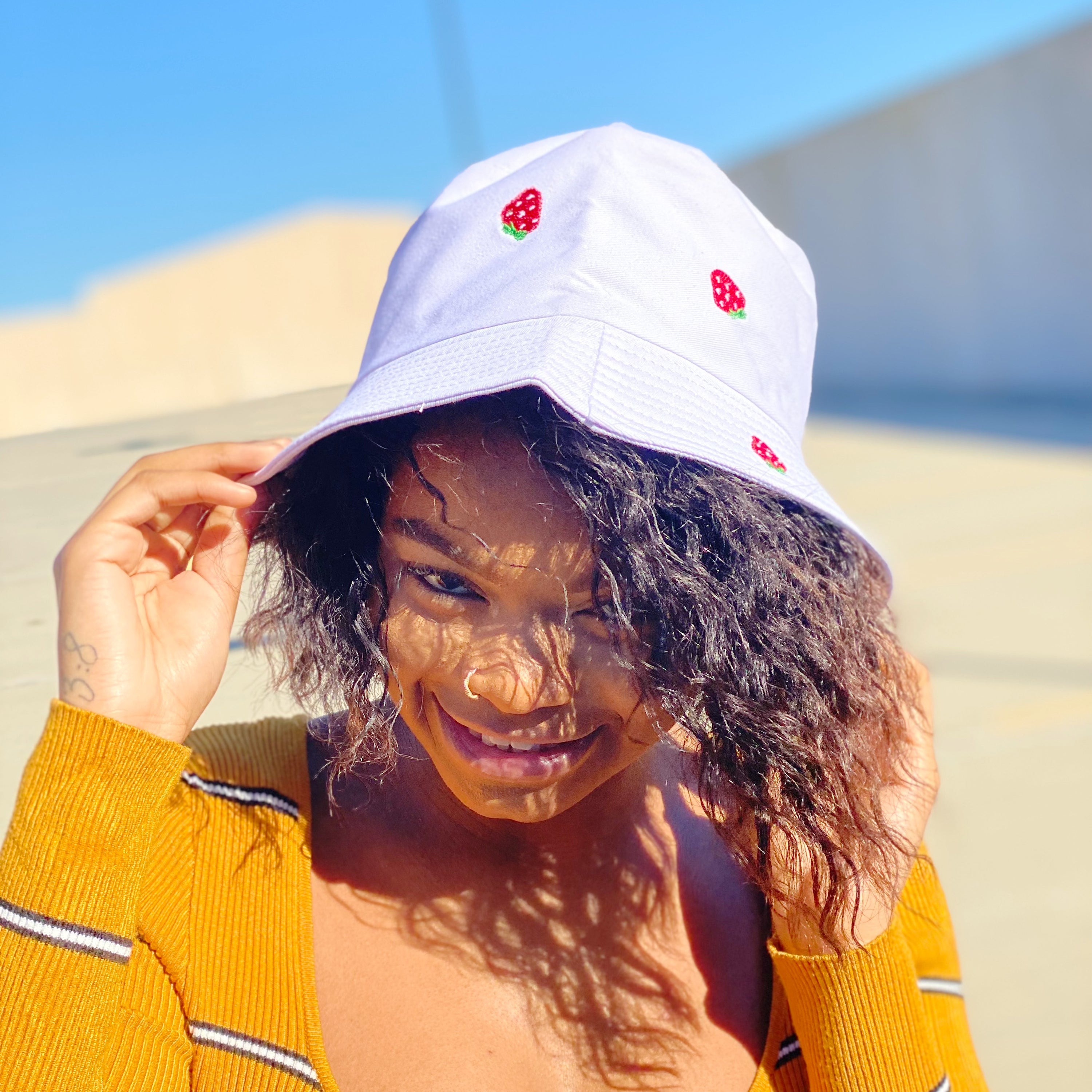 A stylish Sweety Fruity Bucket Hat featuring colorful embroidered fruit patterns on a high-quality cotton fabric, perfect for summer wear.