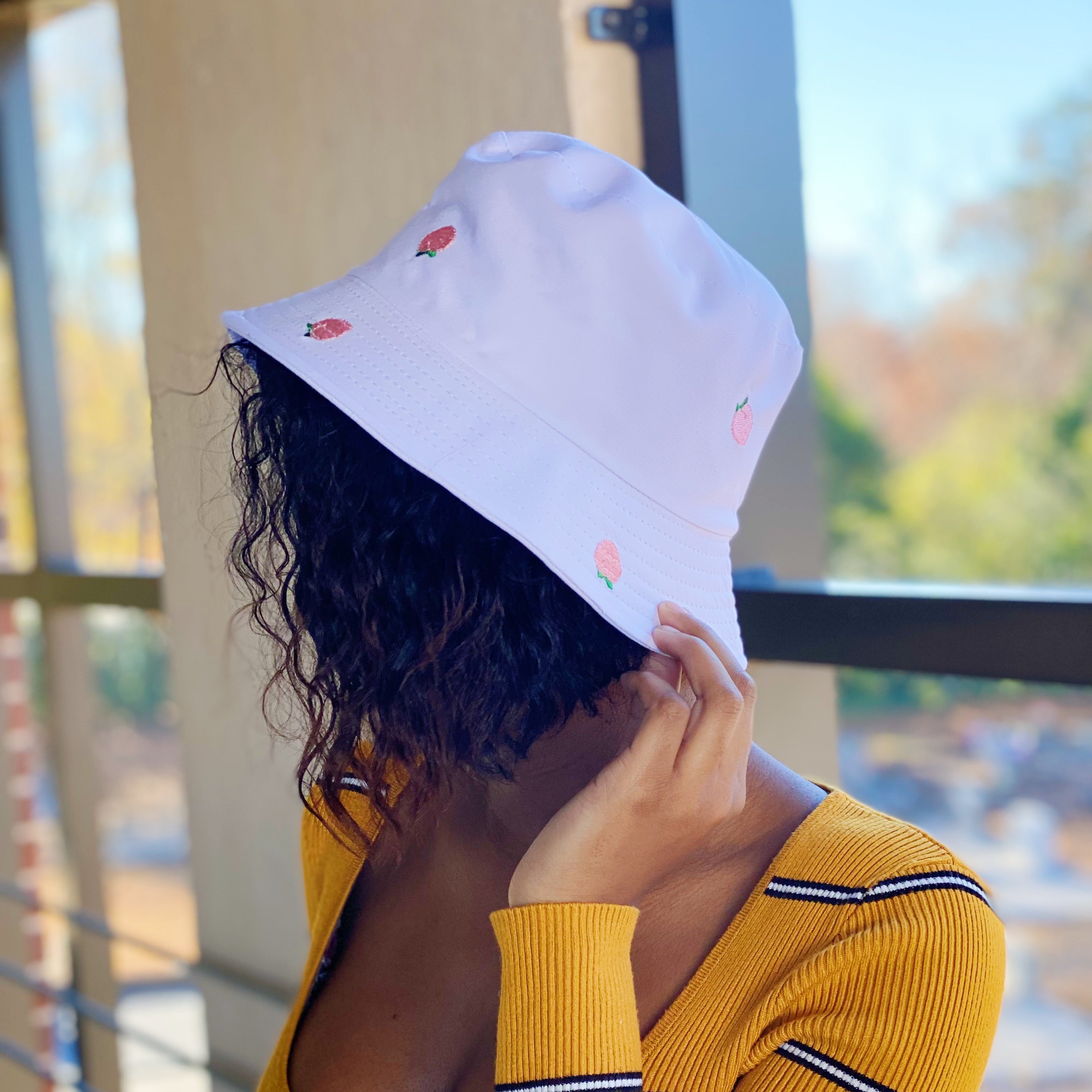 A stylish Sweety Fruity Bucket Hat featuring colorful embroidered fruit patterns on a high-quality cotton fabric, perfect for summer wear.