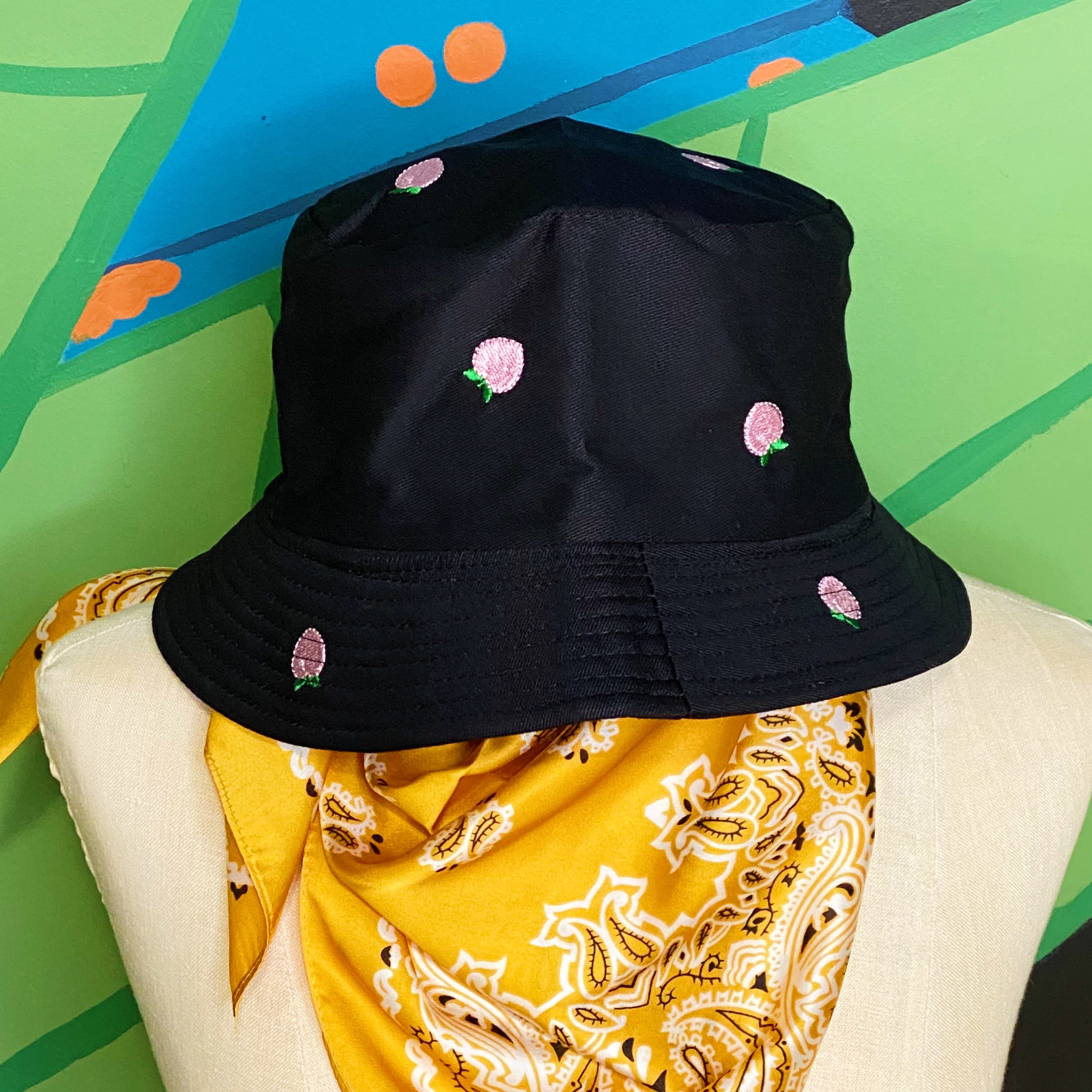 A stylish Sweety Fruity Bucket Hat featuring colorful embroidered fruit patterns on a high-quality cotton fabric, perfect for summer wear.