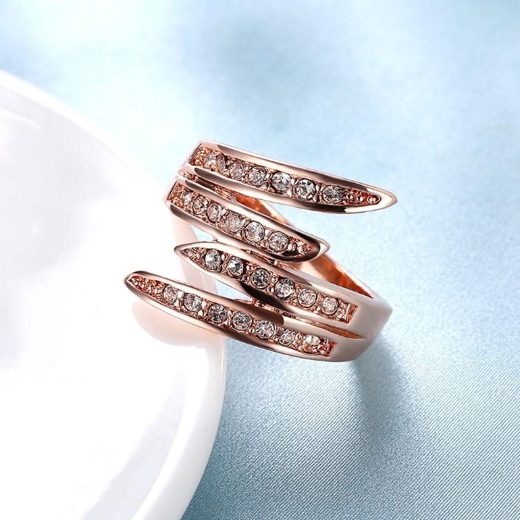 Elegant Swirl Cocktail Ring in 14K Rose Gold with sparkling crystals, showcasing a unique swirl design.