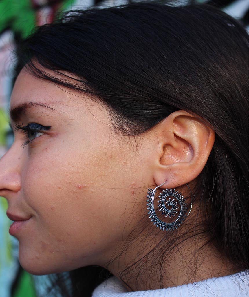 A pair of Urbiana Swivel Hoop Earrings featuring intricate bohemian design, crafted from brass and silver, perfect for sensitive skin.