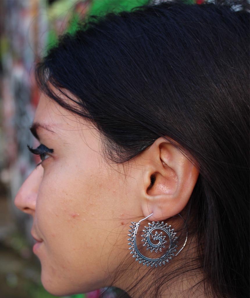 A pair of Urbiana Swivel Hoop Earrings featuring intricate bohemian design, crafted from brass and silver, perfect for sensitive skin.