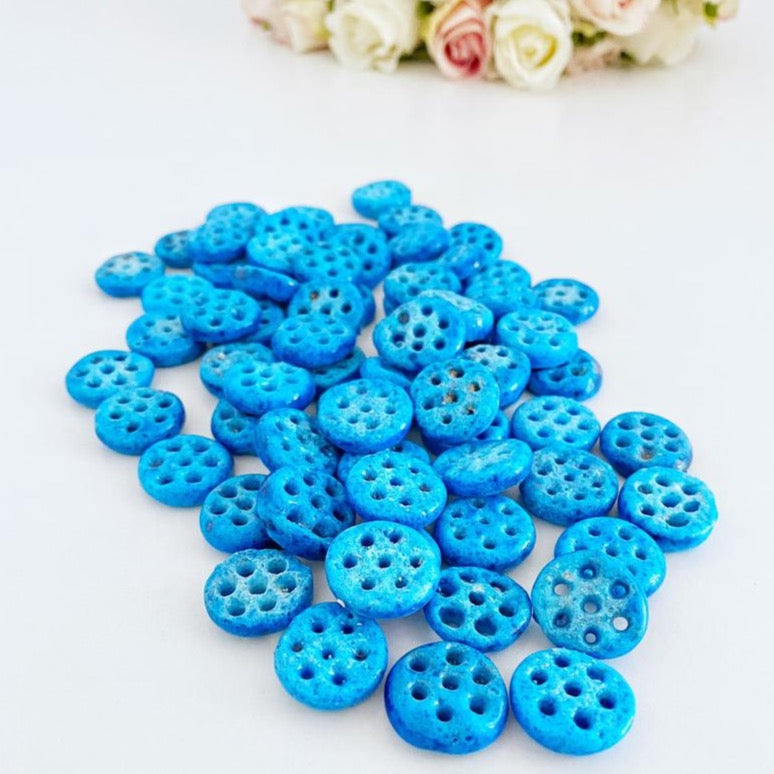 A collection of Syriac Evil Eye Beads featuring 7 holes, ideal for jewelry making, showcasing vibrant colors and intricate designs.