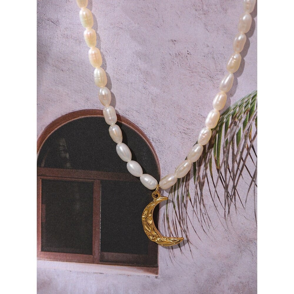 Taletha Crescent Gold Moon Natural Pearl Charm Necklace featuring a pearl coin and gold chain, symbolizing elegance and durability.