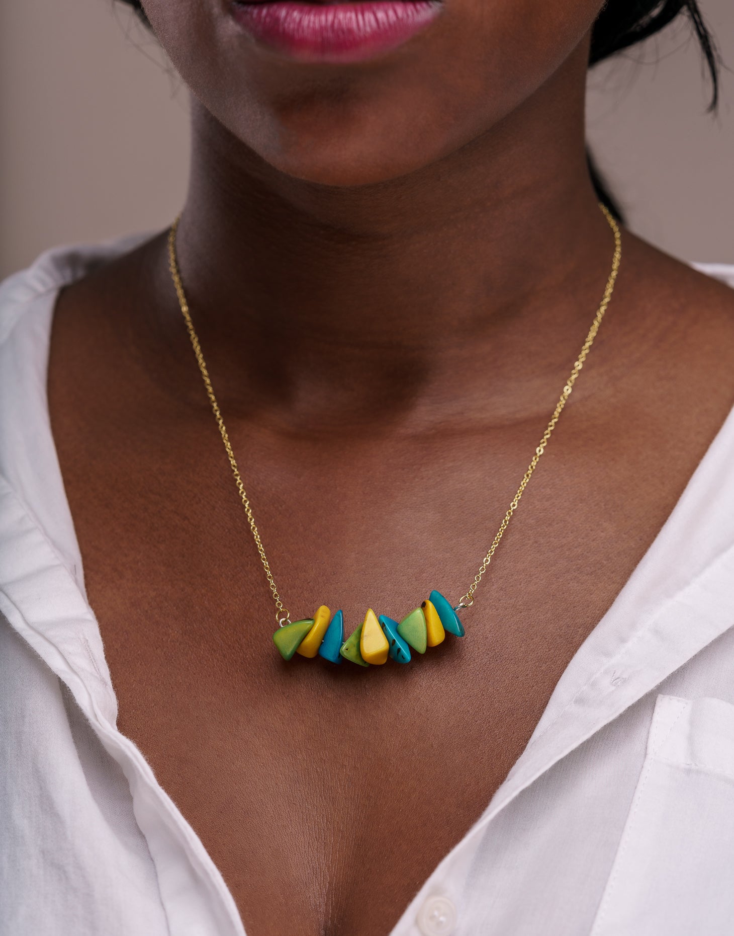 Tapajos Tagua Chain Necklace featuring organic Tagua nut shavings and a brass chain, elegantly displayed.