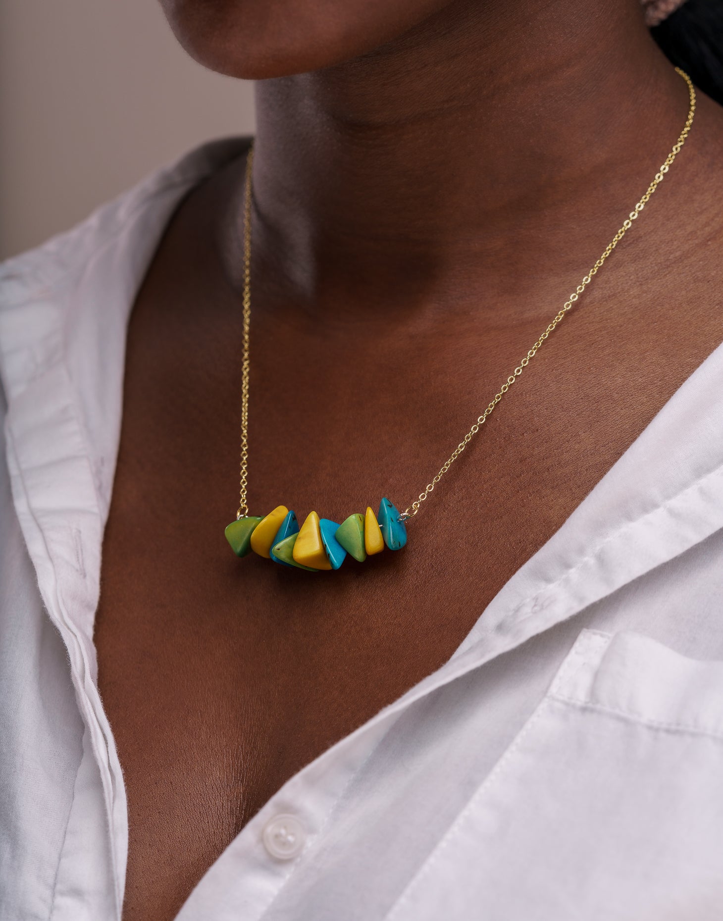 Tapajos Tagua Chain Necklace featuring organic Tagua nut shavings and a brass chain, elegantly displayed.