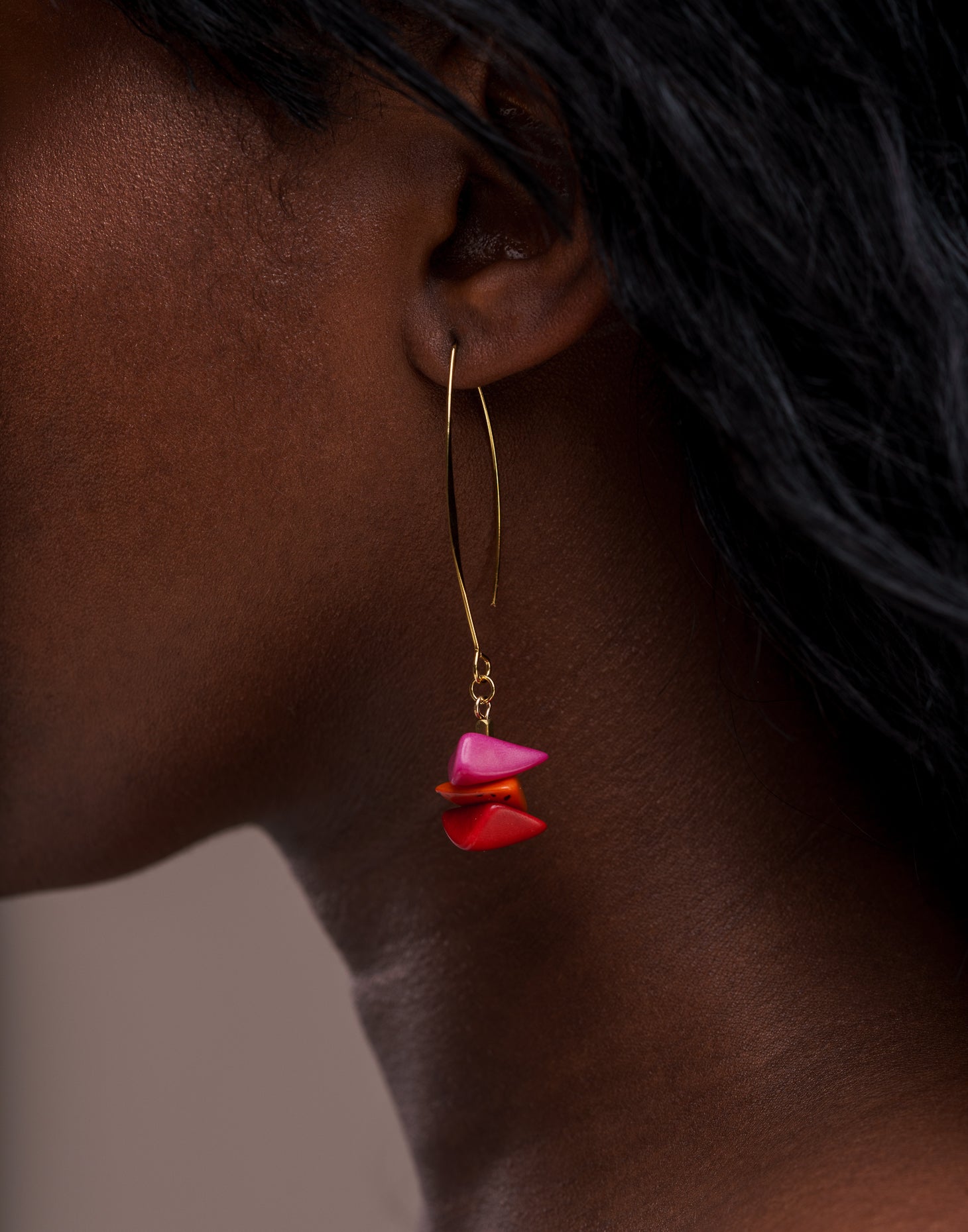 Tapajos Tagua Drop Earrings in vibrant berry colors, featuring tagua nut and raw brass hooks, showcasing a unique and eco-friendly design.