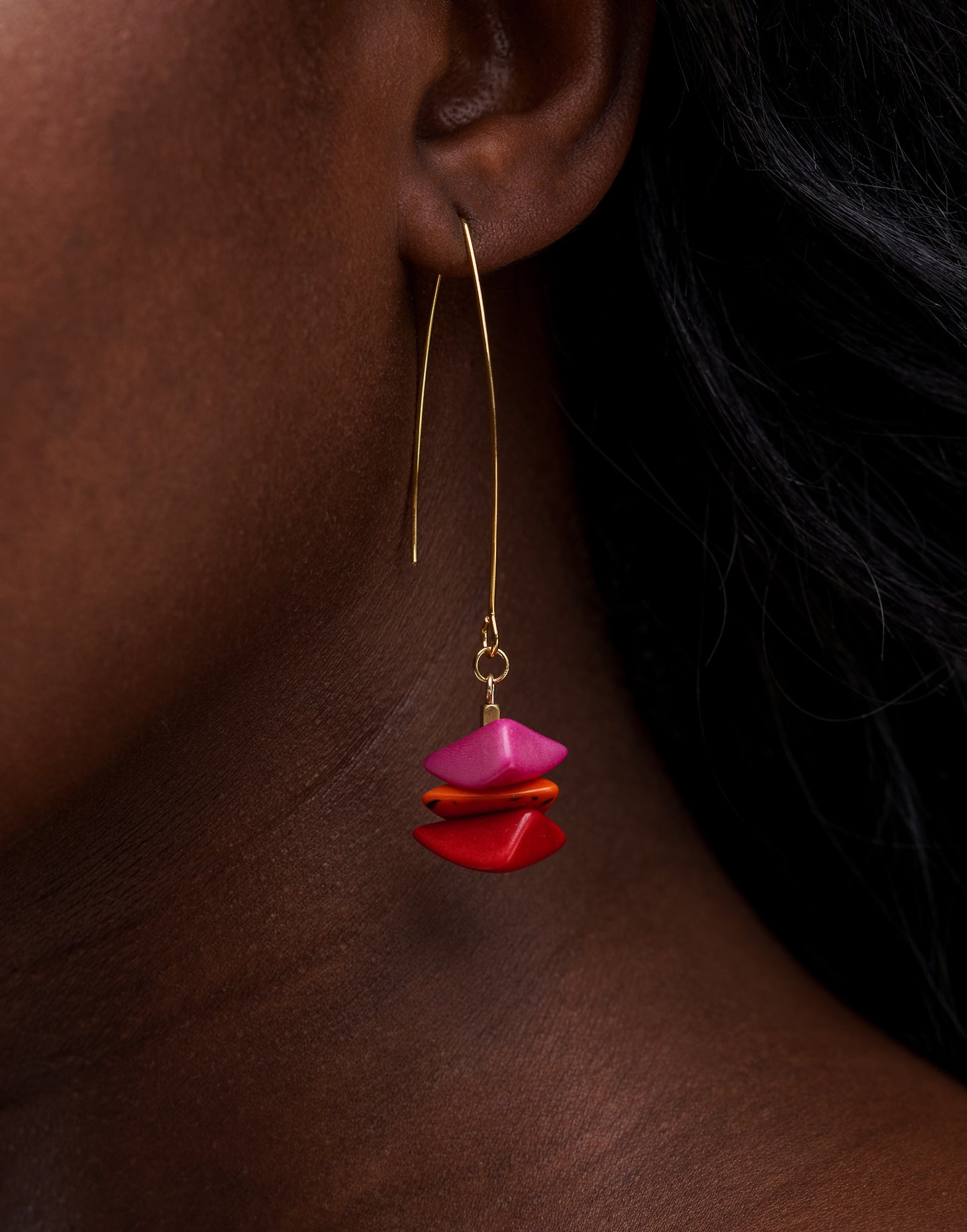 Tapajos Tagua Drop Earrings in vibrant berry colors, featuring tagua nut and raw brass hooks, showcasing a unique and eco-friendly design.