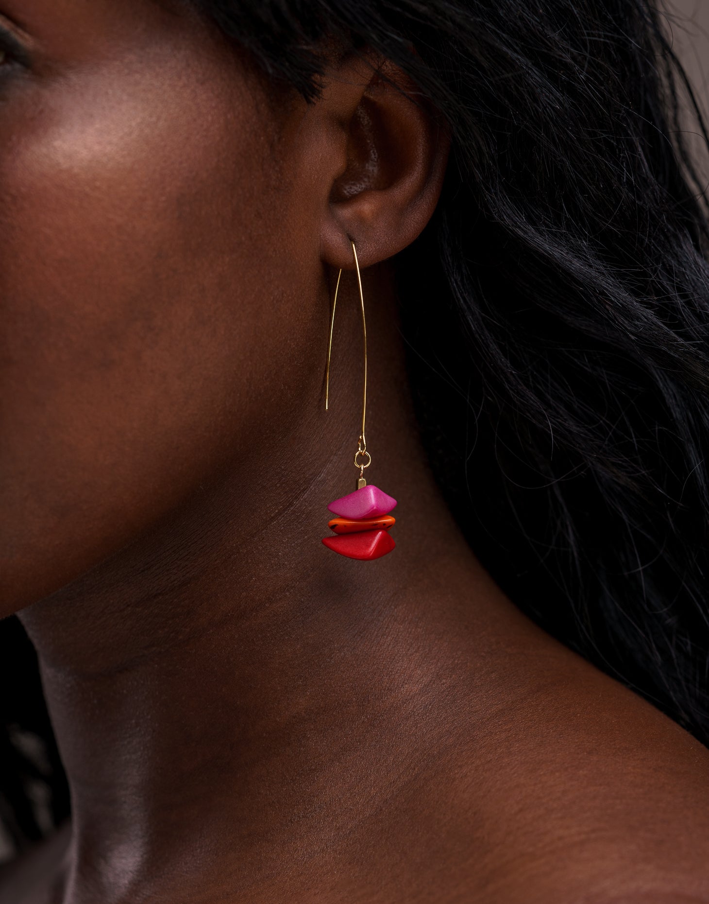 Tapajos Tagua Drop Earrings in vibrant berry colors, featuring tagua nut and raw brass hooks, showcasing a unique and eco-friendly design.