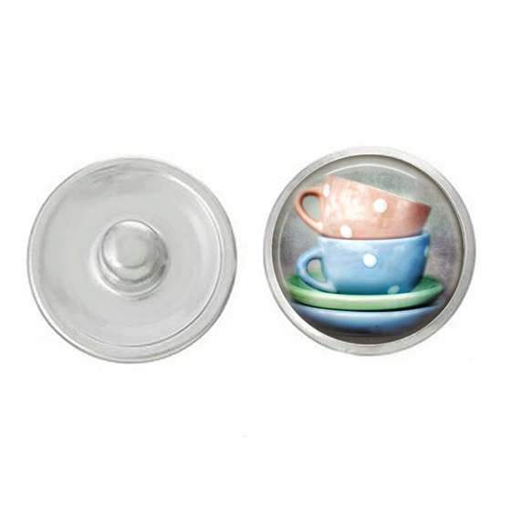 A pair of hand-pressed blue and peach tea cup snaps, showcasing intricate designs and vibrant colors, perfect for customizing jewelry.