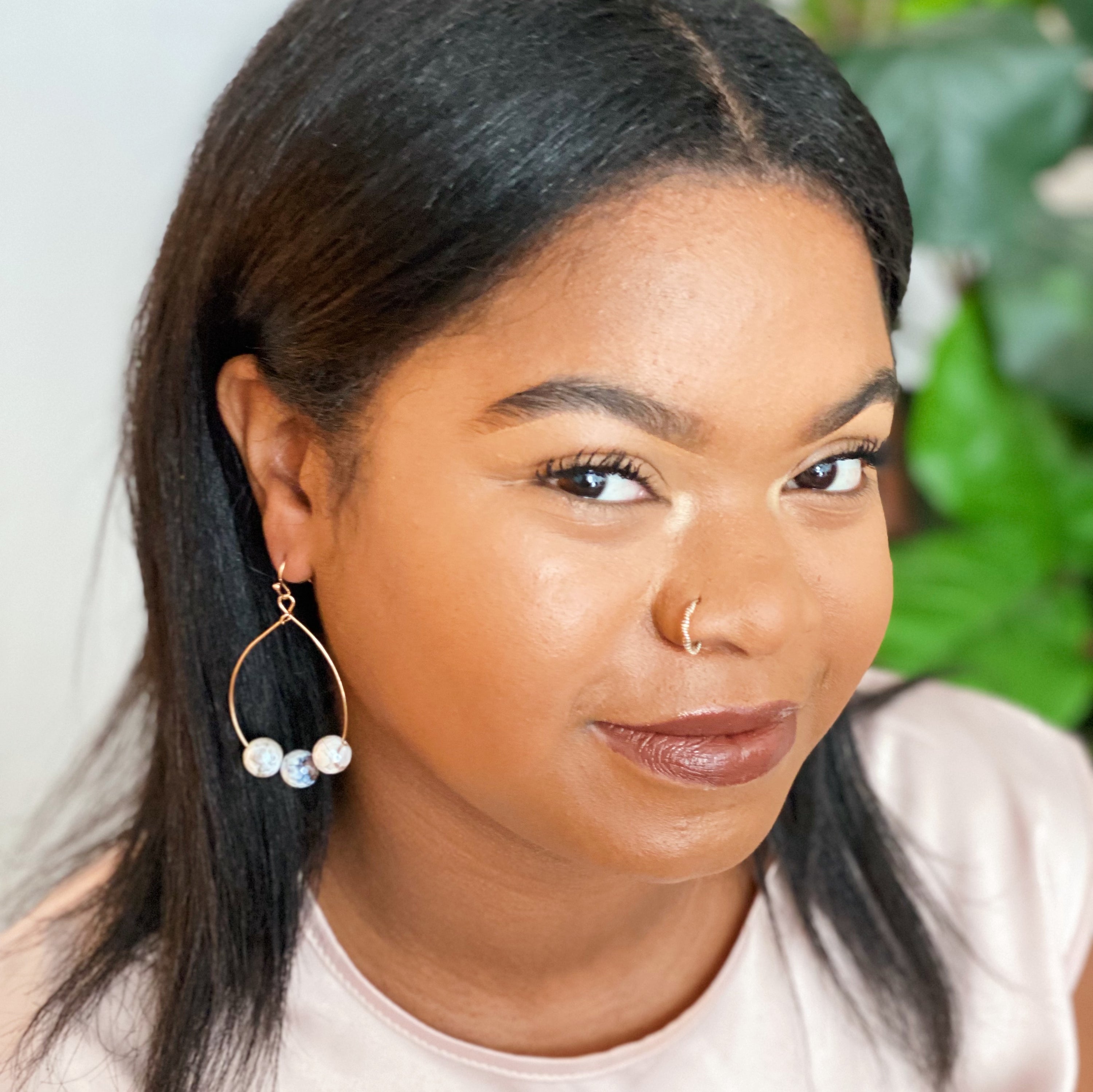 Elegant teardrop wire earrings featuring dimensionally cut glass beads and gold plated alloy metal.