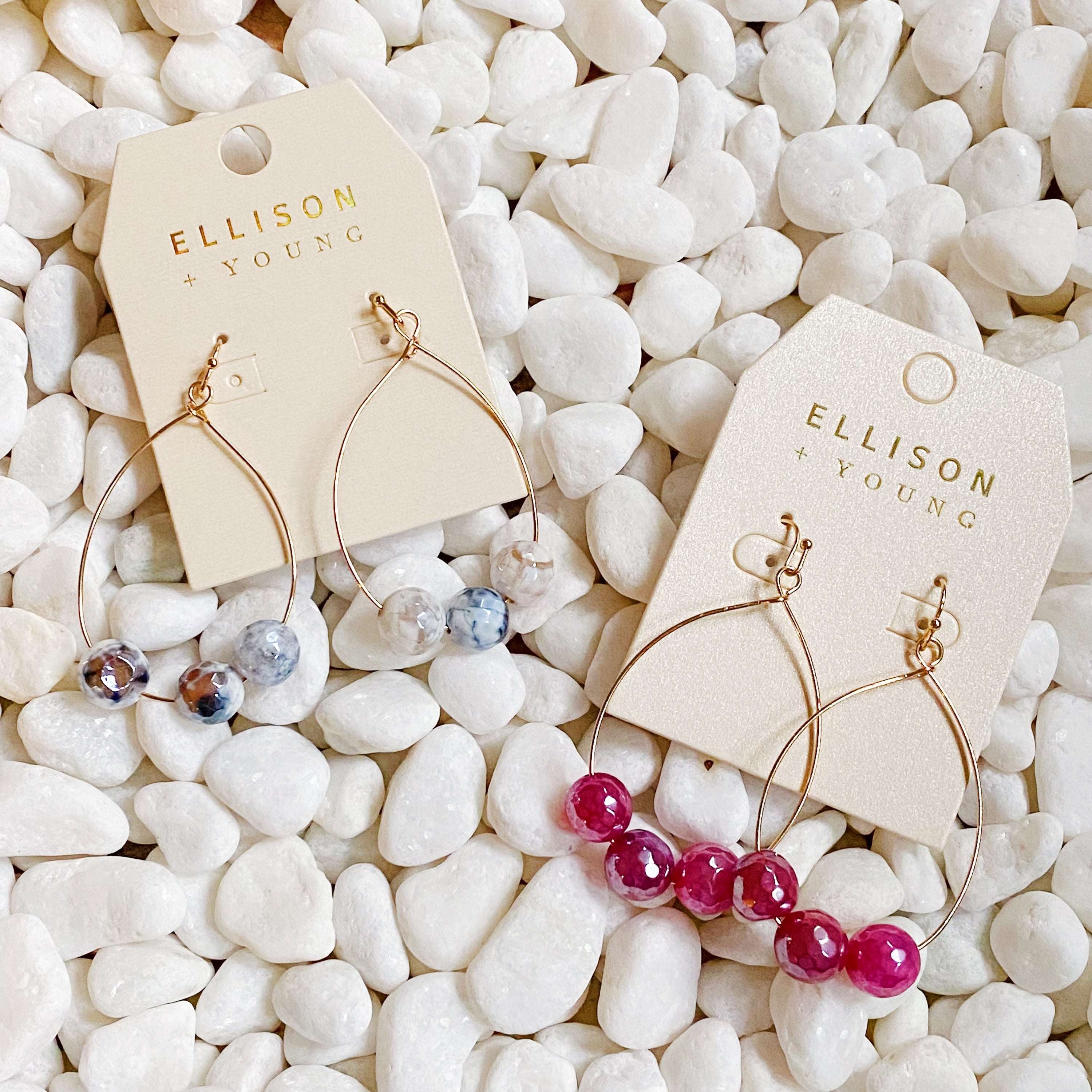 Elegant teardrop wire earrings featuring dimensionally cut glass beads and gold plated alloy metal.