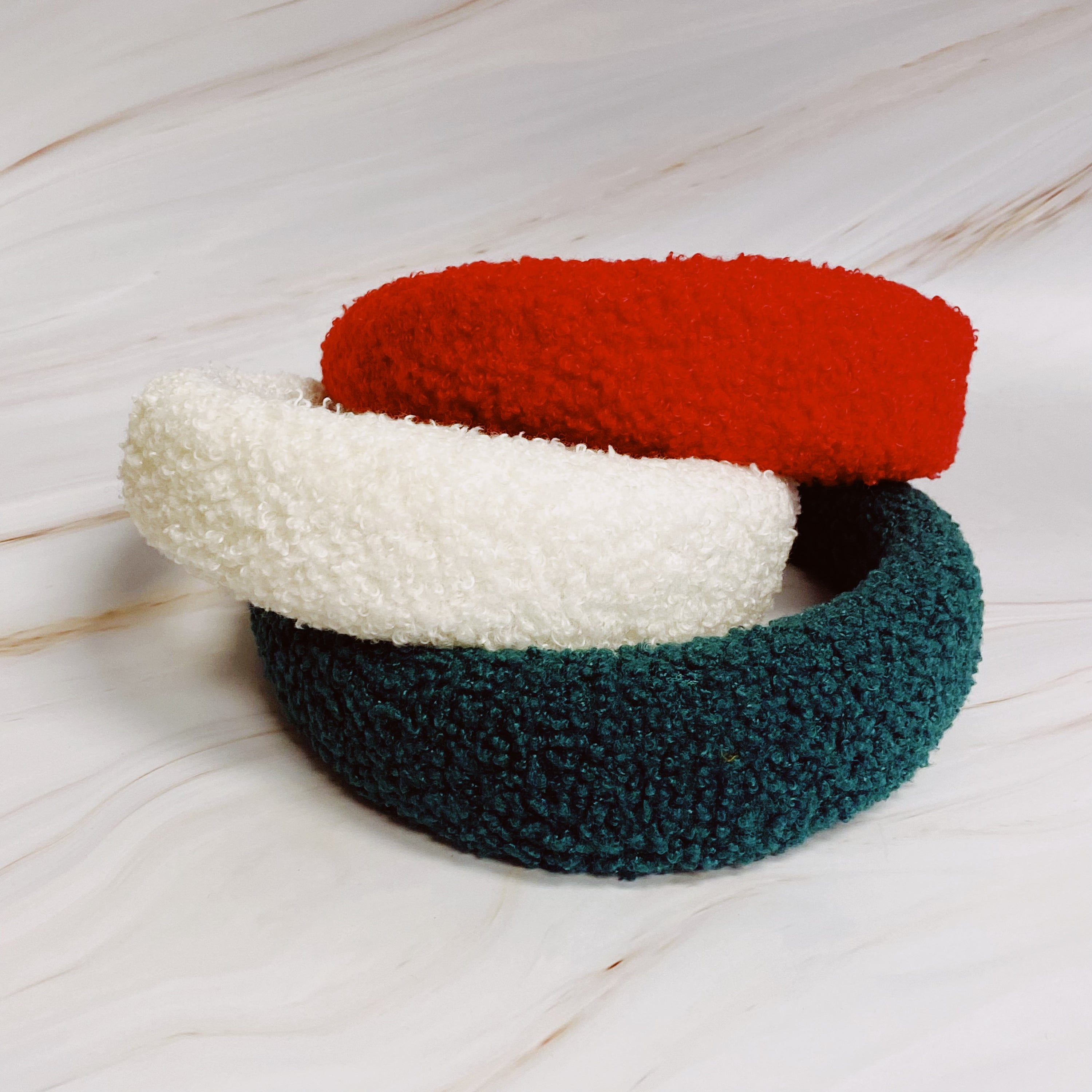 A stylish Teddy Cozy Headband made from soft, fuzzy materials, perfect for keeping hair in place while adding a cute touch to any outfit.