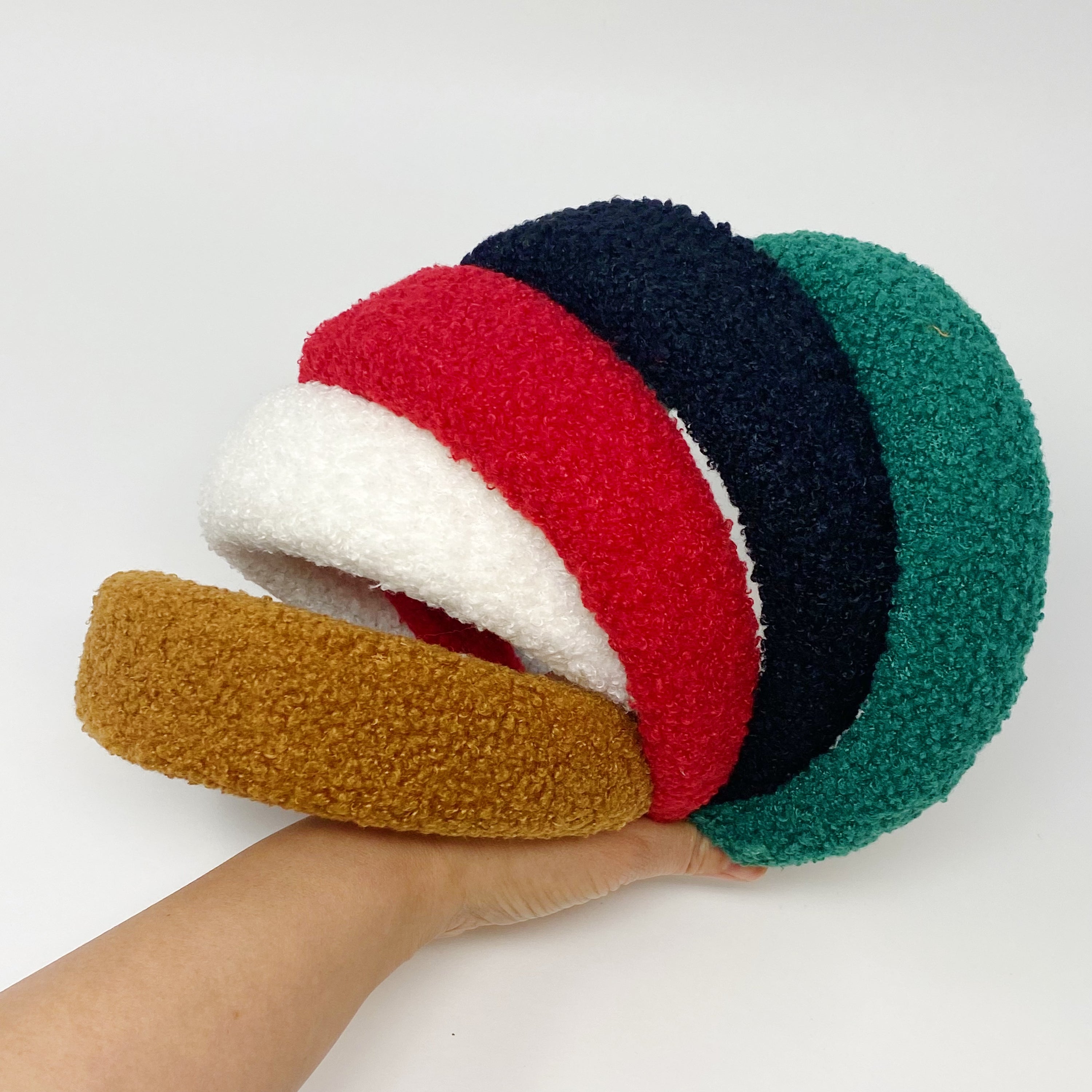 A stylish Teddy Cozy Headband made from soft, fuzzy materials, perfect for keeping hair in place while adding a cute touch to any outfit.