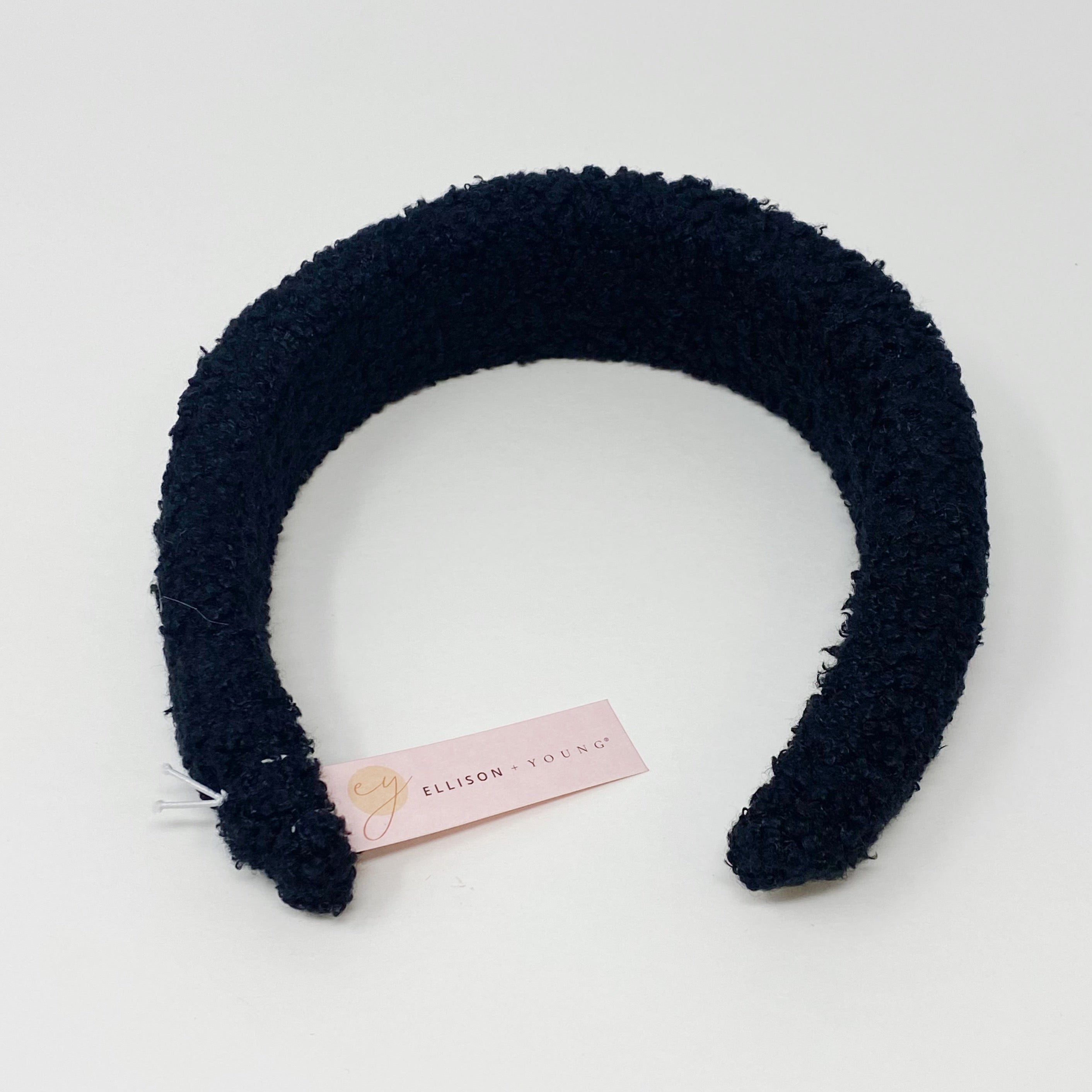 A stylish Teddy Cozy Headband made from soft, fuzzy materials, perfect for keeping hair in place while adding a cute touch to any outfit.