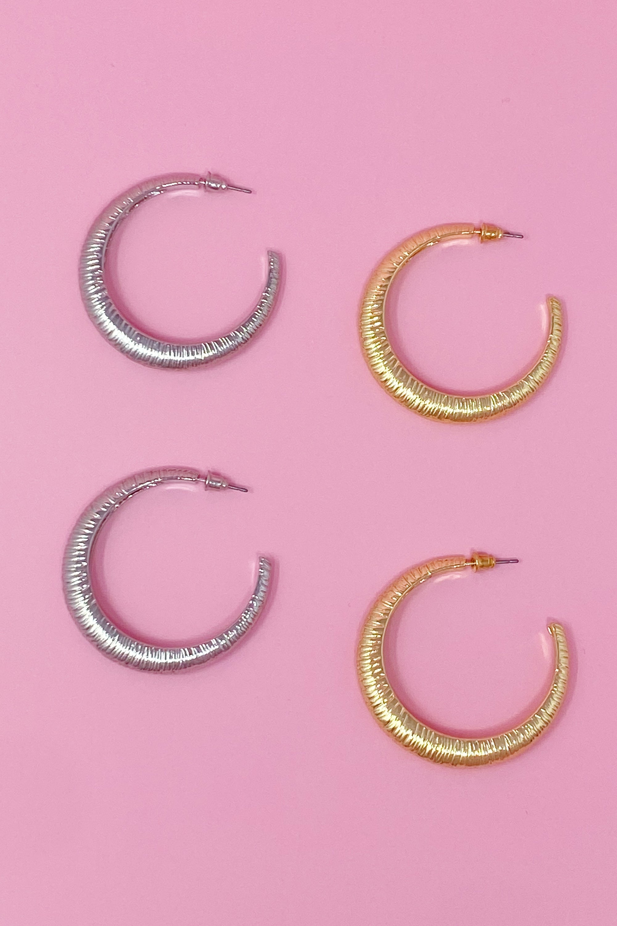 A pair of textured daily hoop earrings with a dimensional finish, perfect for everyday wear and special occasions.