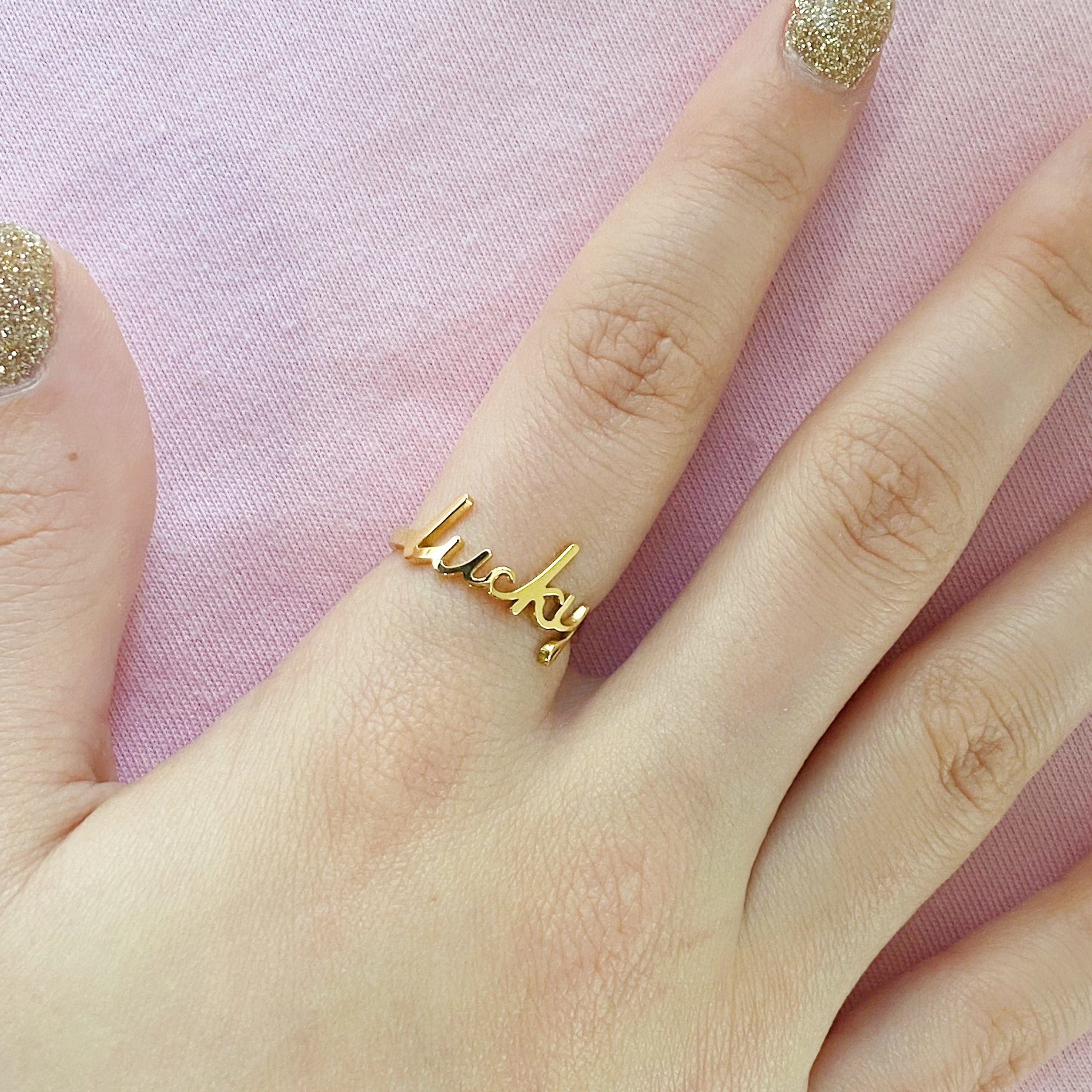 The Always Remember Ring featuring delicate script, adjustable design, and 18K gold plating on stainless steel.