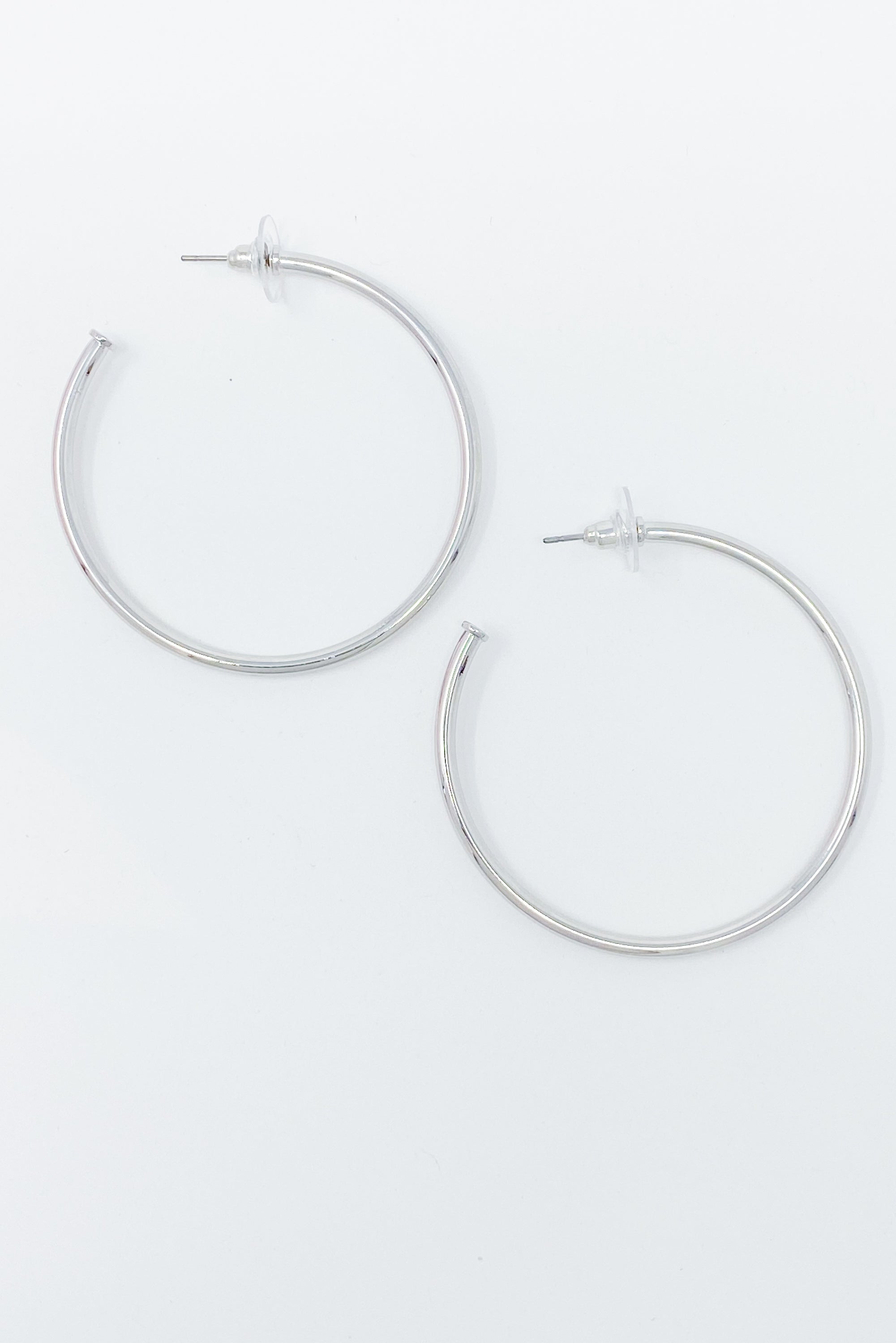 Brilliant silver hoop earrings with shiny rhodium plating, featuring a 2-inch radius design, perfect for stylish everyday wear.