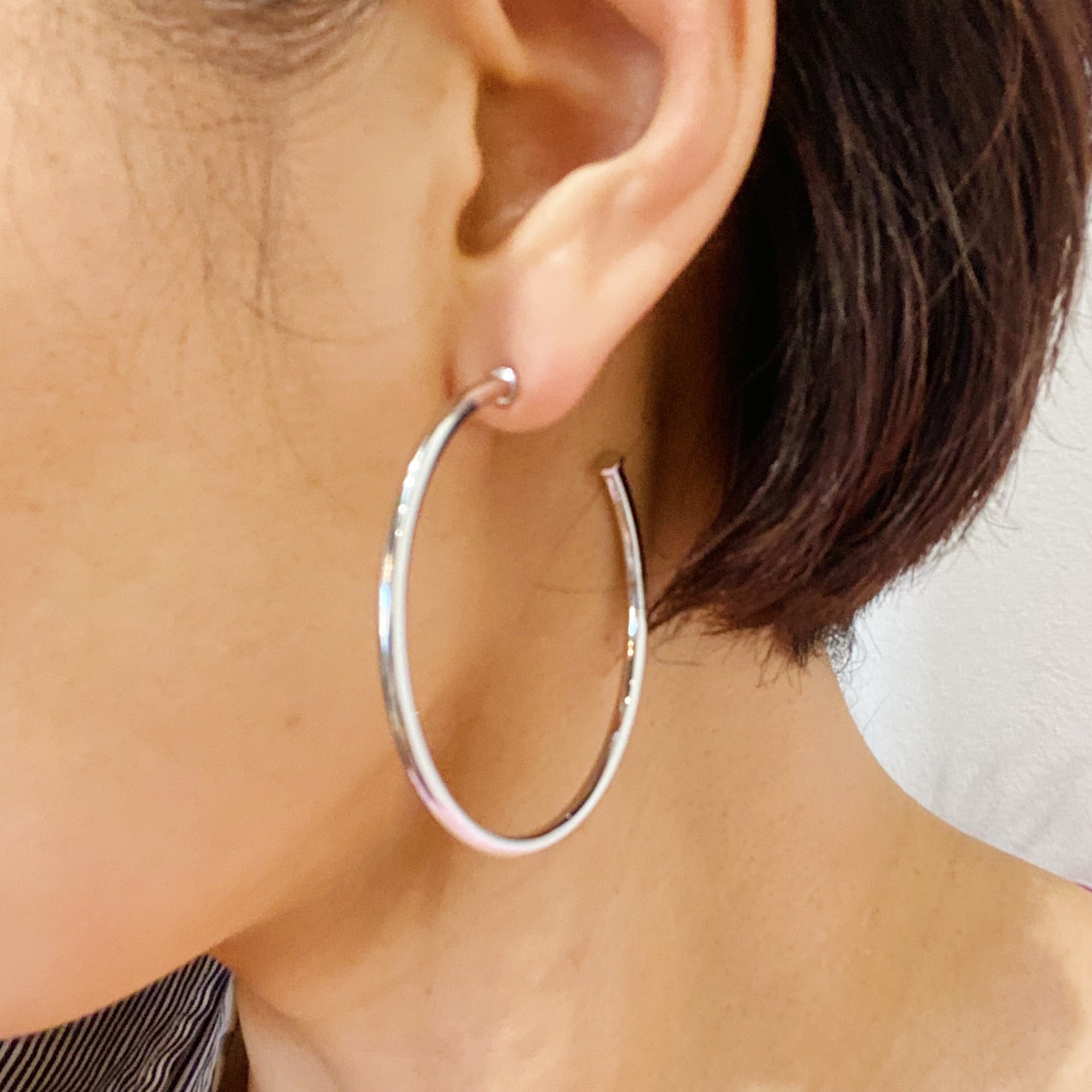 Brilliant silver hoop earrings with shiny rhodium plating, featuring a 2-inch radius design, perfect for stylish everyday wear.