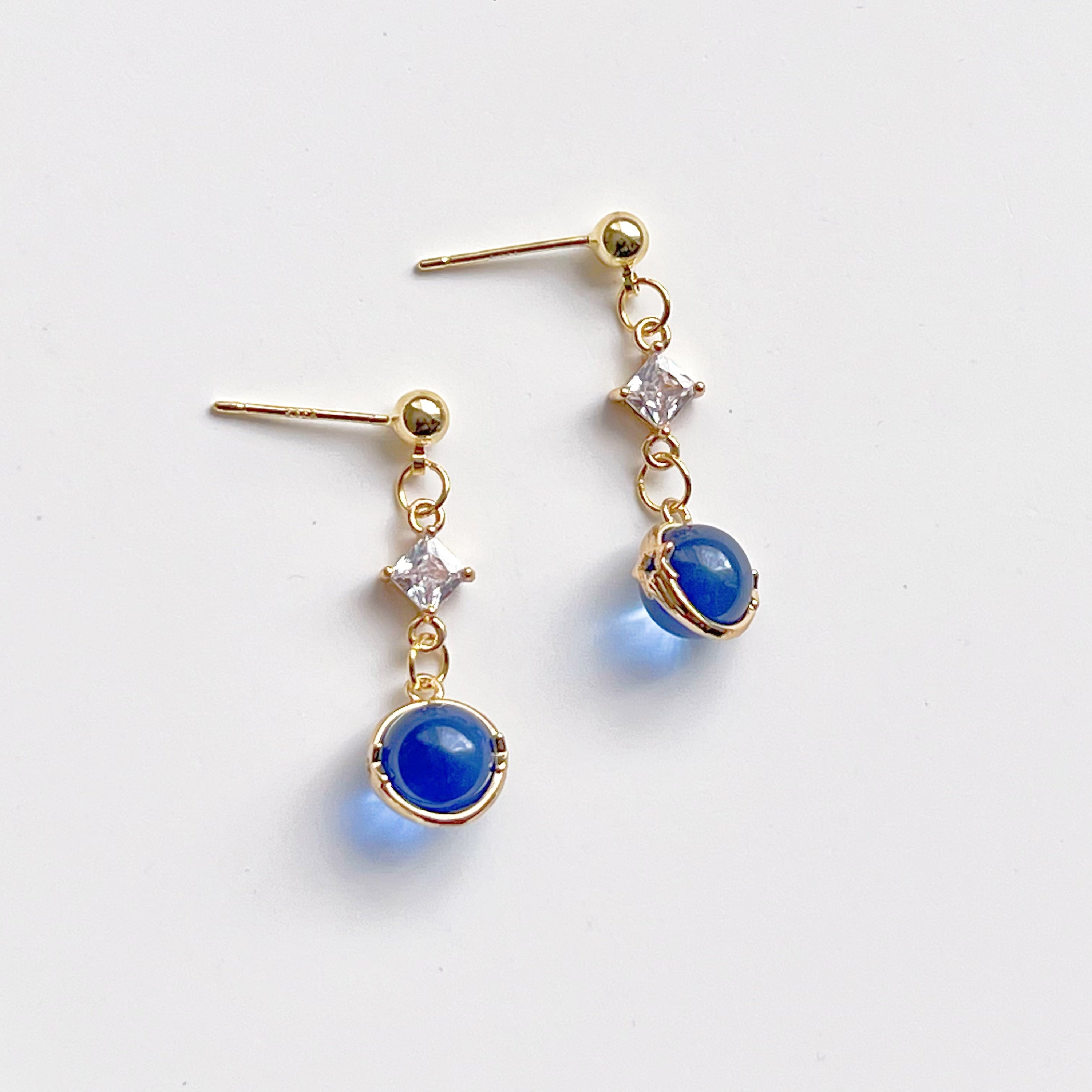 Elegant Blue Planet Neptune Drop Earrings featuring recycled glass beads and sterling silver studs, beautifully packaged in a gift box.