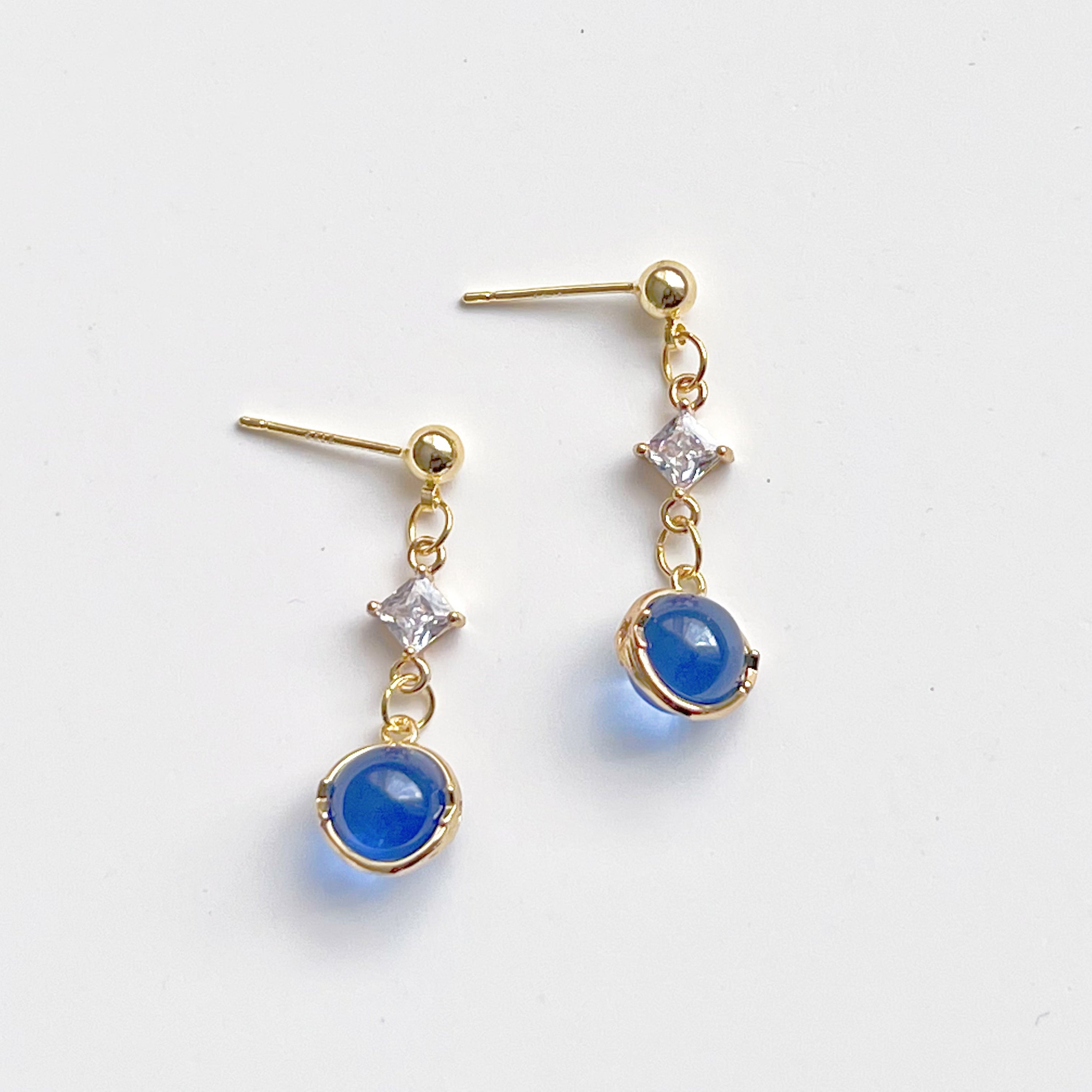 Elegant Blue Planet Neptune Drop Earrings featuring recycled glass beads and sterling silver studs, beautifully packaged in a gift box.