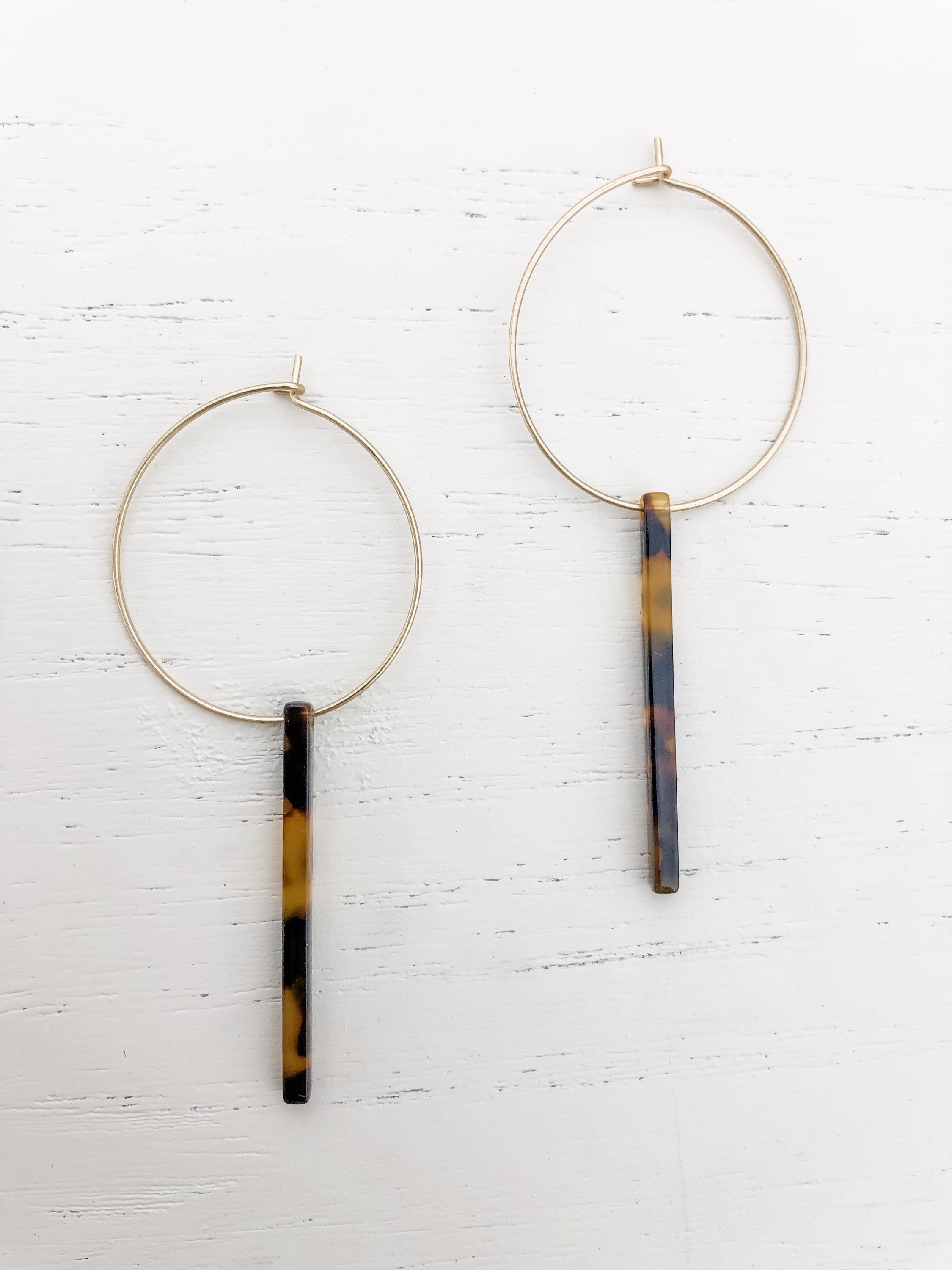 Gold plated hoop earrings featuring dark tortoise resin detail, measuring approximately 2-5/8 inches in length.