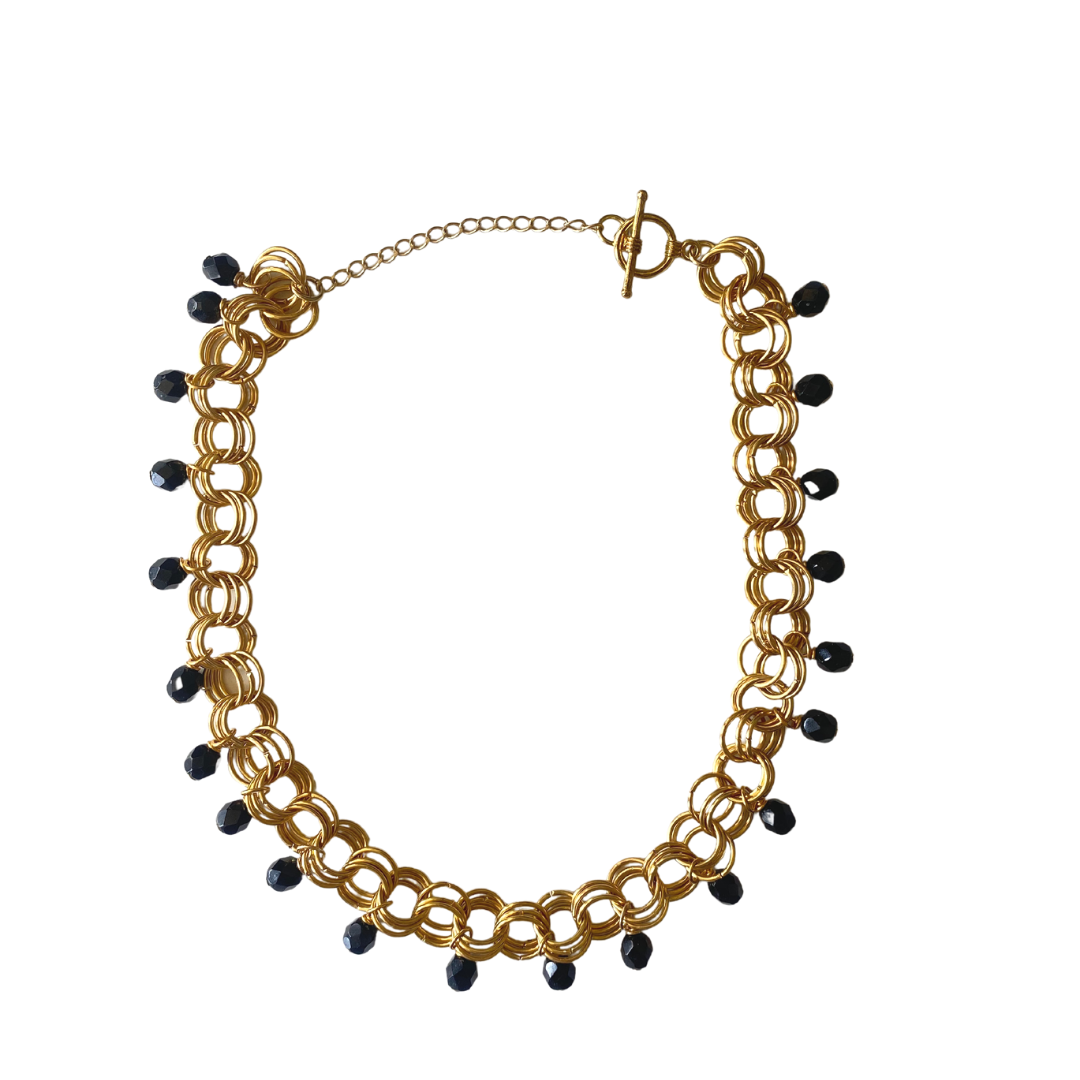 The Christina Choker in Jet Black featuring Czech glass beads and various metal finishes, elegantly displayed on a soft background.