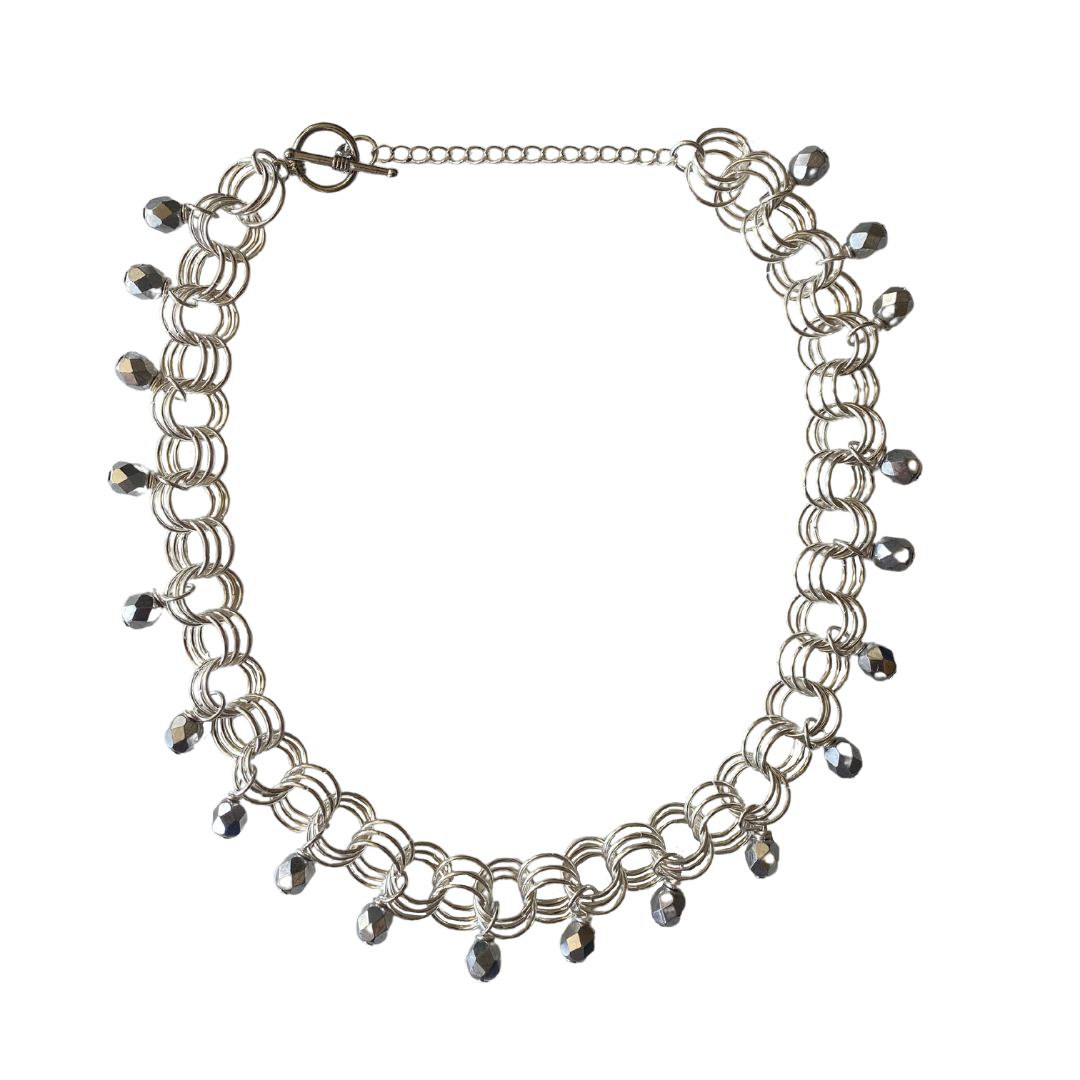 The Christina Choker in Metallic Silver featuring Czech glass beads and adjustable links, elegantly displayed on a neutral background.