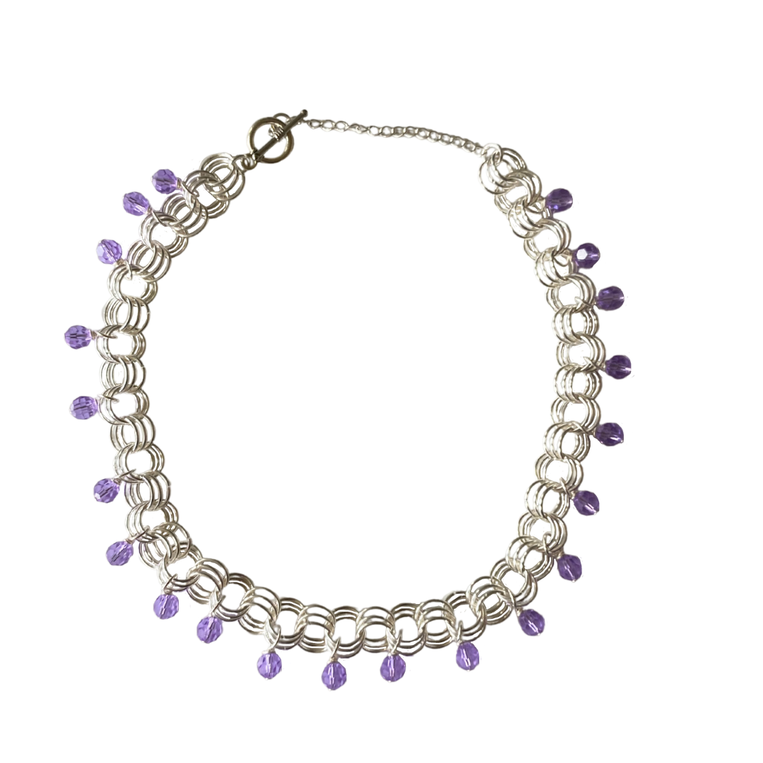 The Christina Choker in Violet featuring Czech glass beads on a delicate chain, showcasing its elegant design.