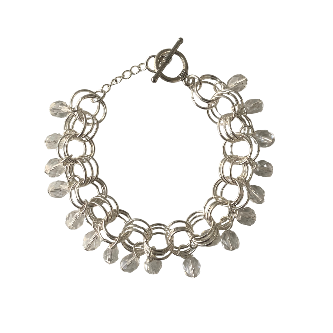 The Donna Bracelet in Clear featuring clear Czech glass beads and gold/silver-plated links with a toggle clasp.