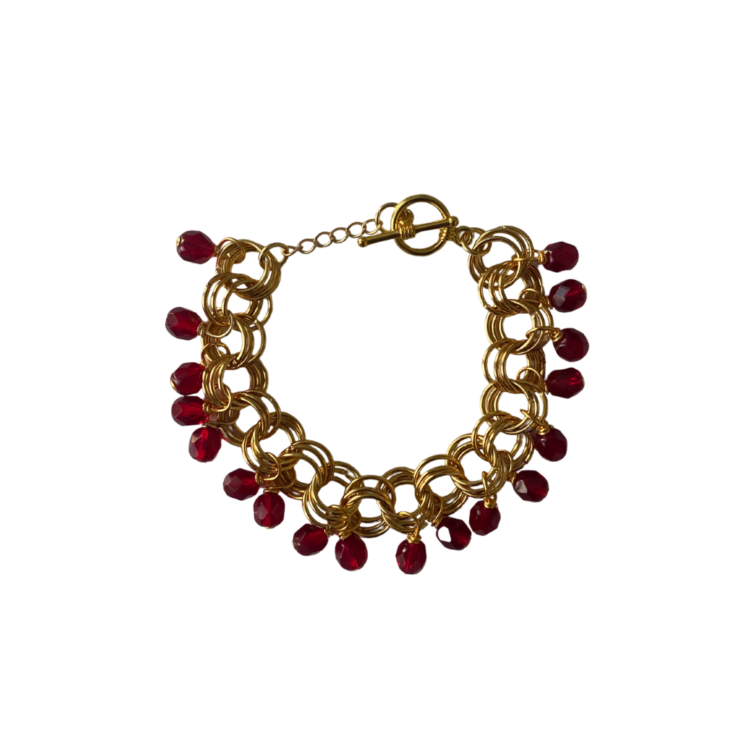 The Donna Bracelet in Garnet Red featuring garnet red Czech glass beads and gold/silver-plated links with a toggle clasp.