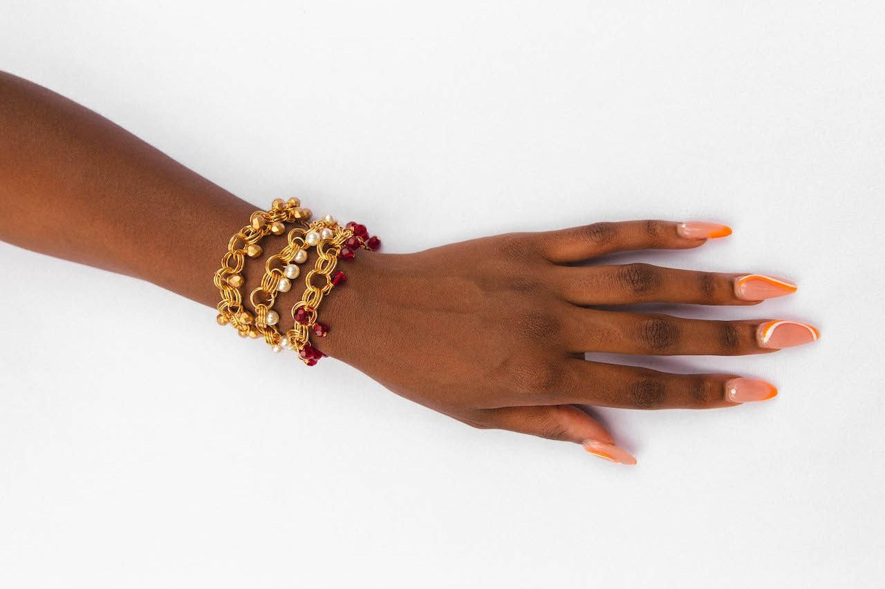 The Donna Bracelet in Garnet Red featuring garnet red Czech glass beads and gold/silver-plated links with a toggle clasp.