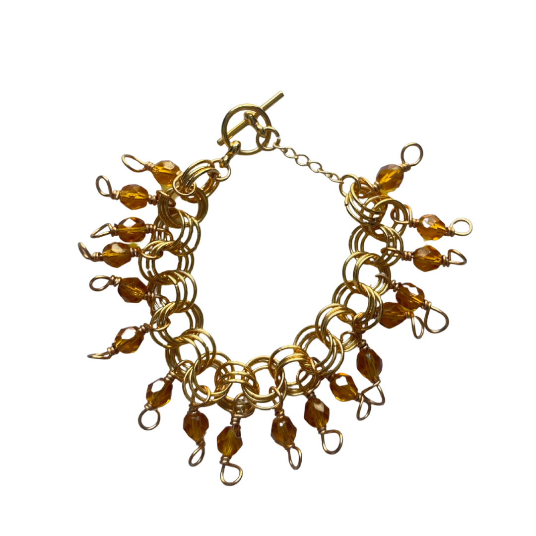 The Donna Bracelet in Honey featuring gold/silver-plated links and honey Czech fire-polished glass beads with a toggle clasp.