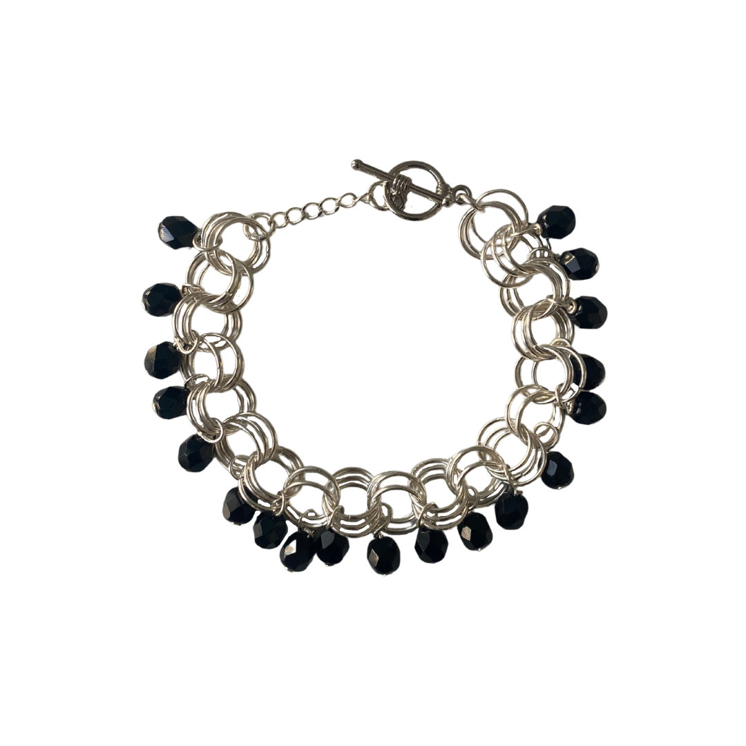 The Donna Bracelet in Jet Black featuring jet black Czech glass beads and gold/silver-plated brass links with a toggle clasp.