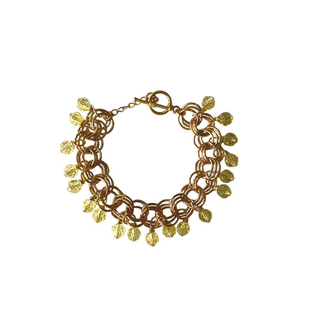 The Donna Bracelet in Jonquil featuring gold/silver-plated links and vibrant jonquil Czech glass beads, elegantly displayed.