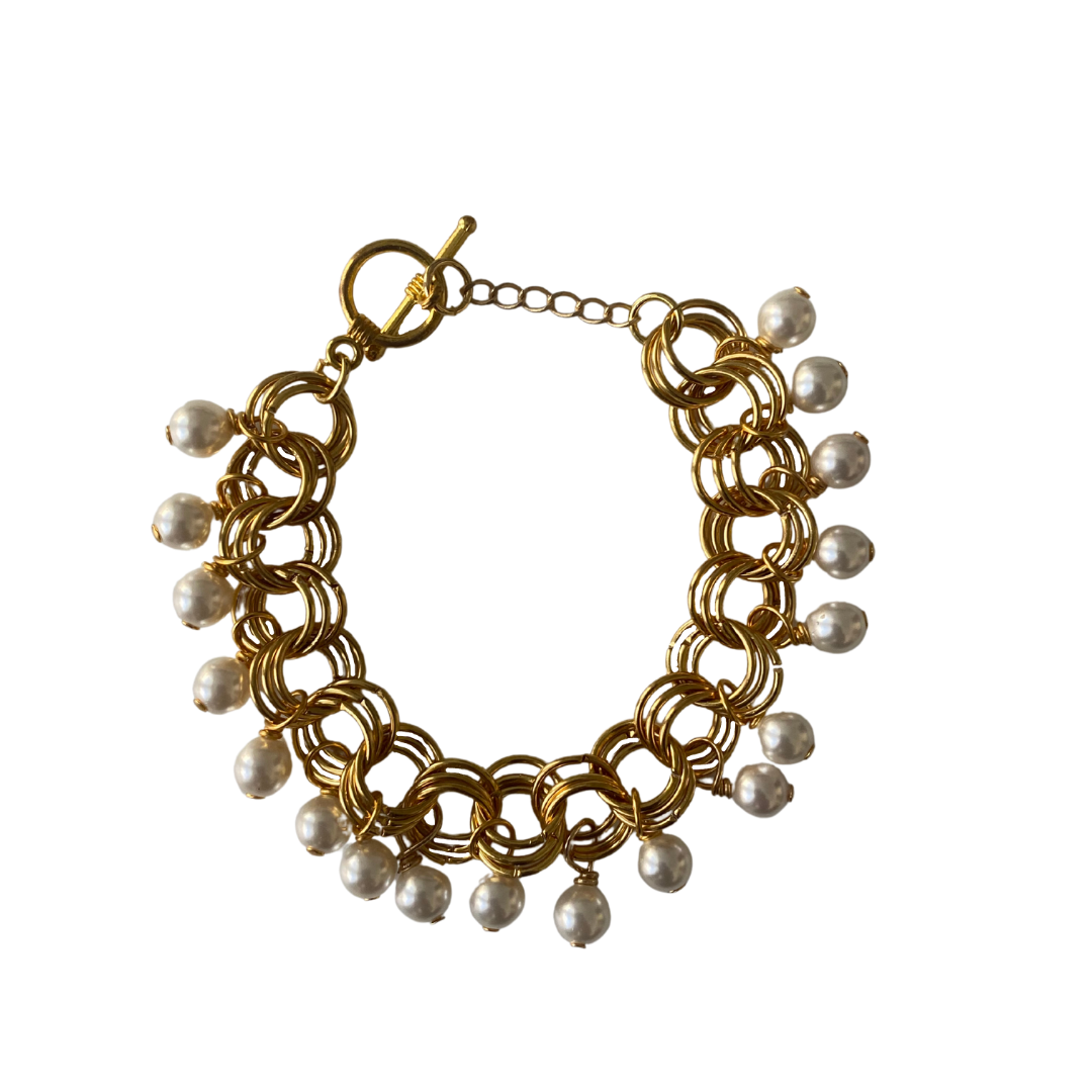 The Donna Bracelet in Pearl featuring gold/silver-plated links and pearl Czech fire-polished glass beads, elegantly designed with a toggle clasp.