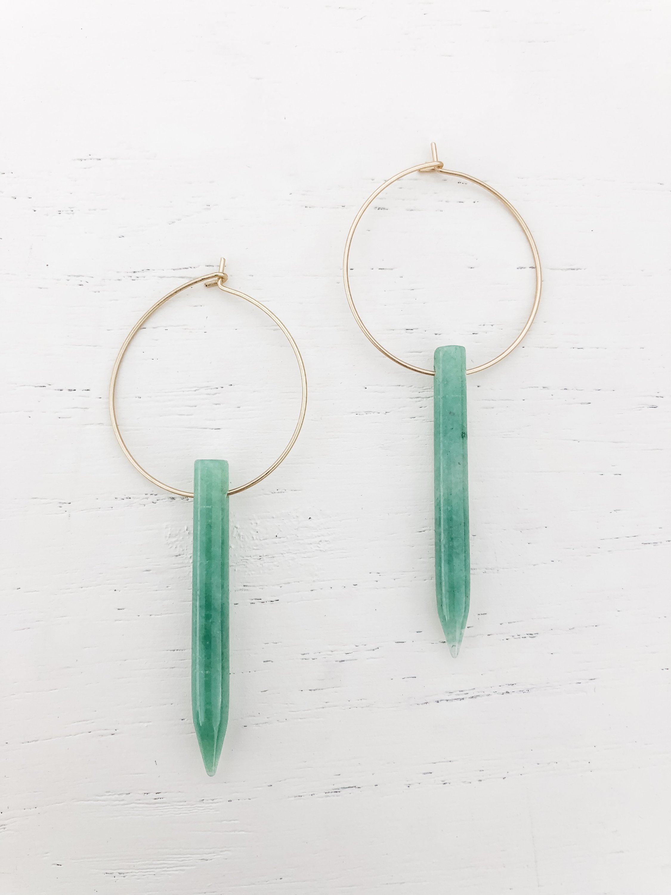 Gold plated hoop earrings featuring a beautiful aventurine spike, elegantly designed for a stylish look.