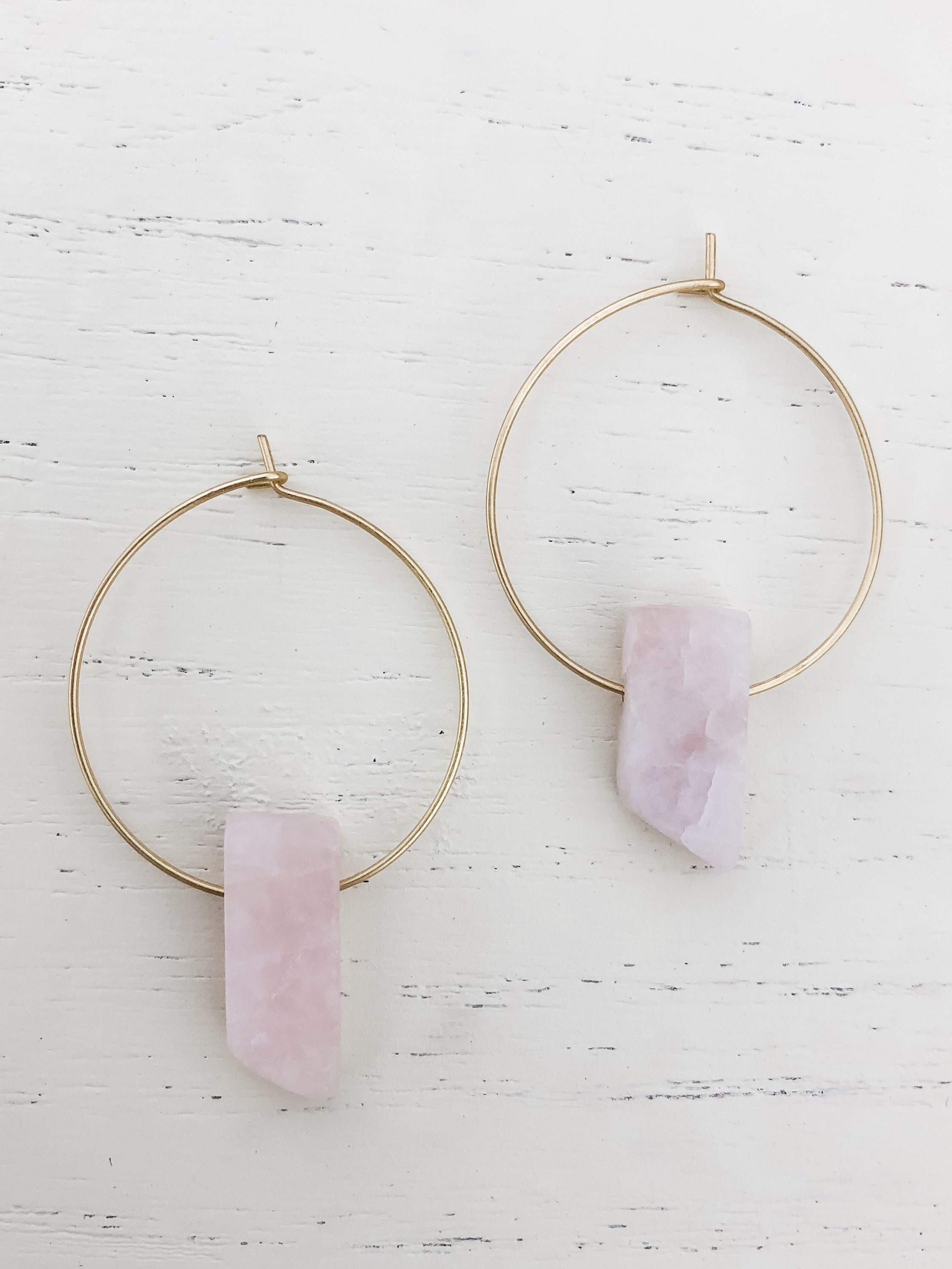 Elegant gold plated hoop earrings featuring a beautiful rose quartz stone, symbolizing love and healing.