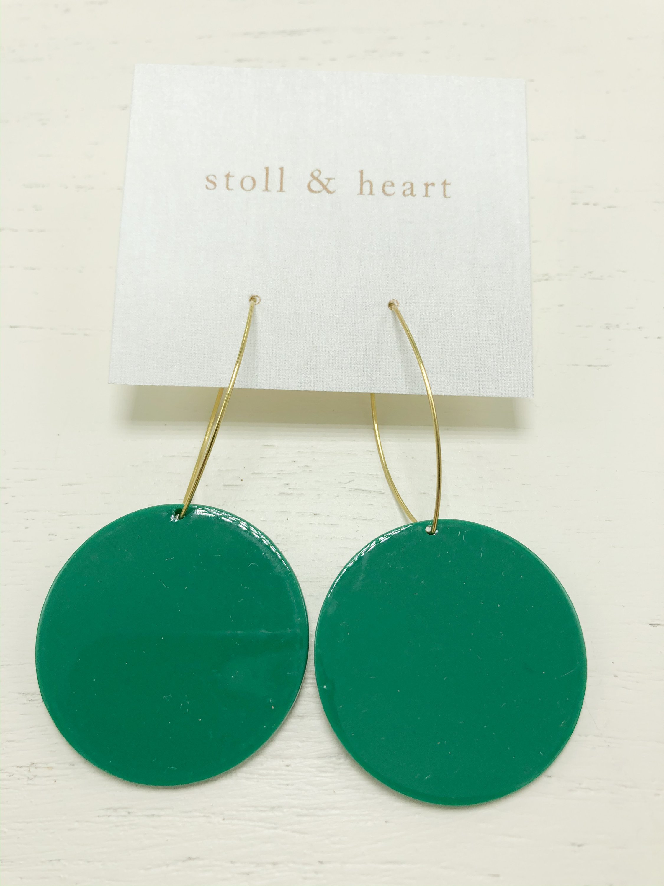 Maddy Roundies Green earrings featuring brass hoops and vibrant green resin detail, elegantly displayed.