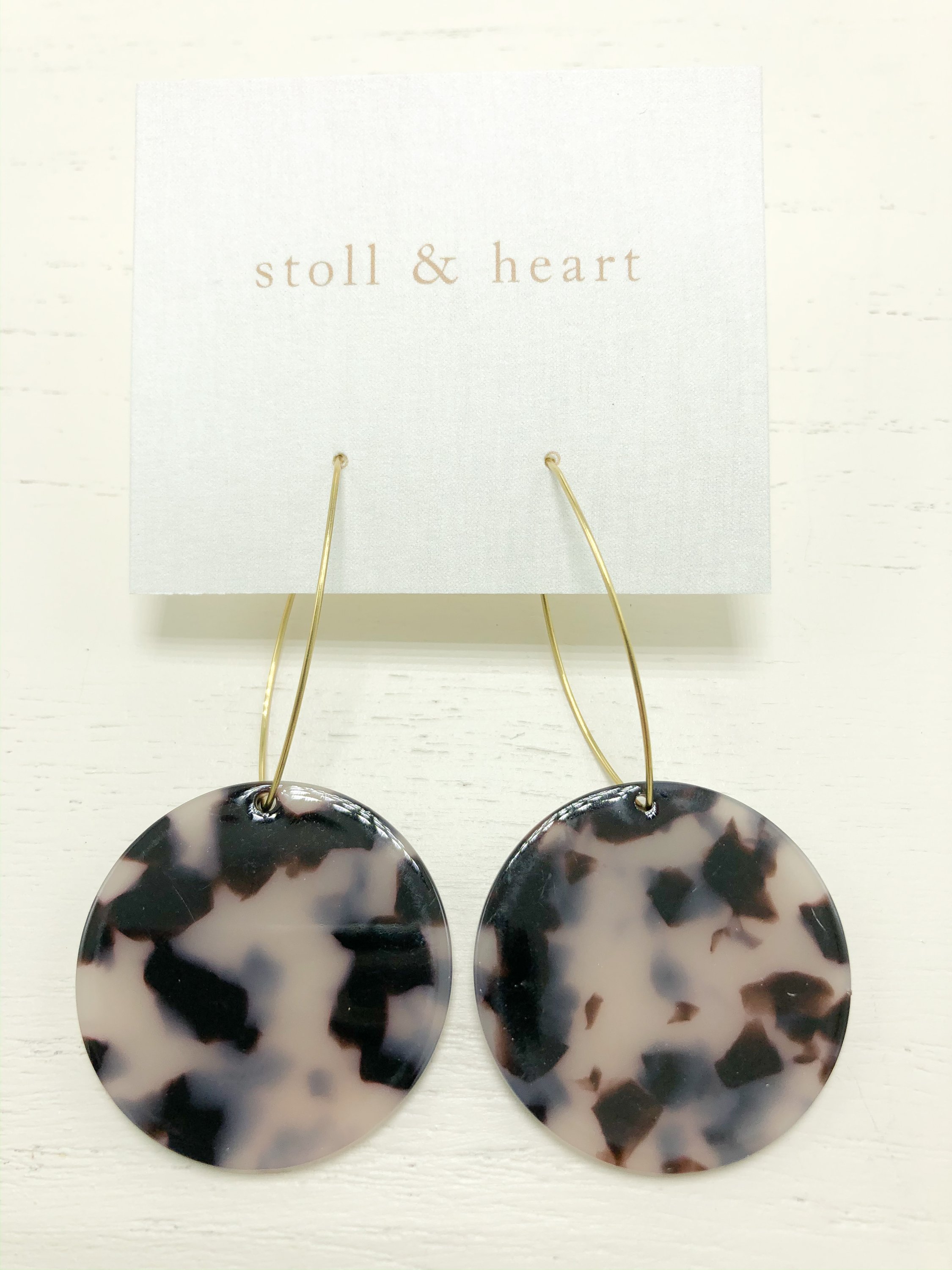 Maddy Roundies Grey Tortoise earrings featuring brass hoops and grey tortoise resin detail, elegantly displayed.