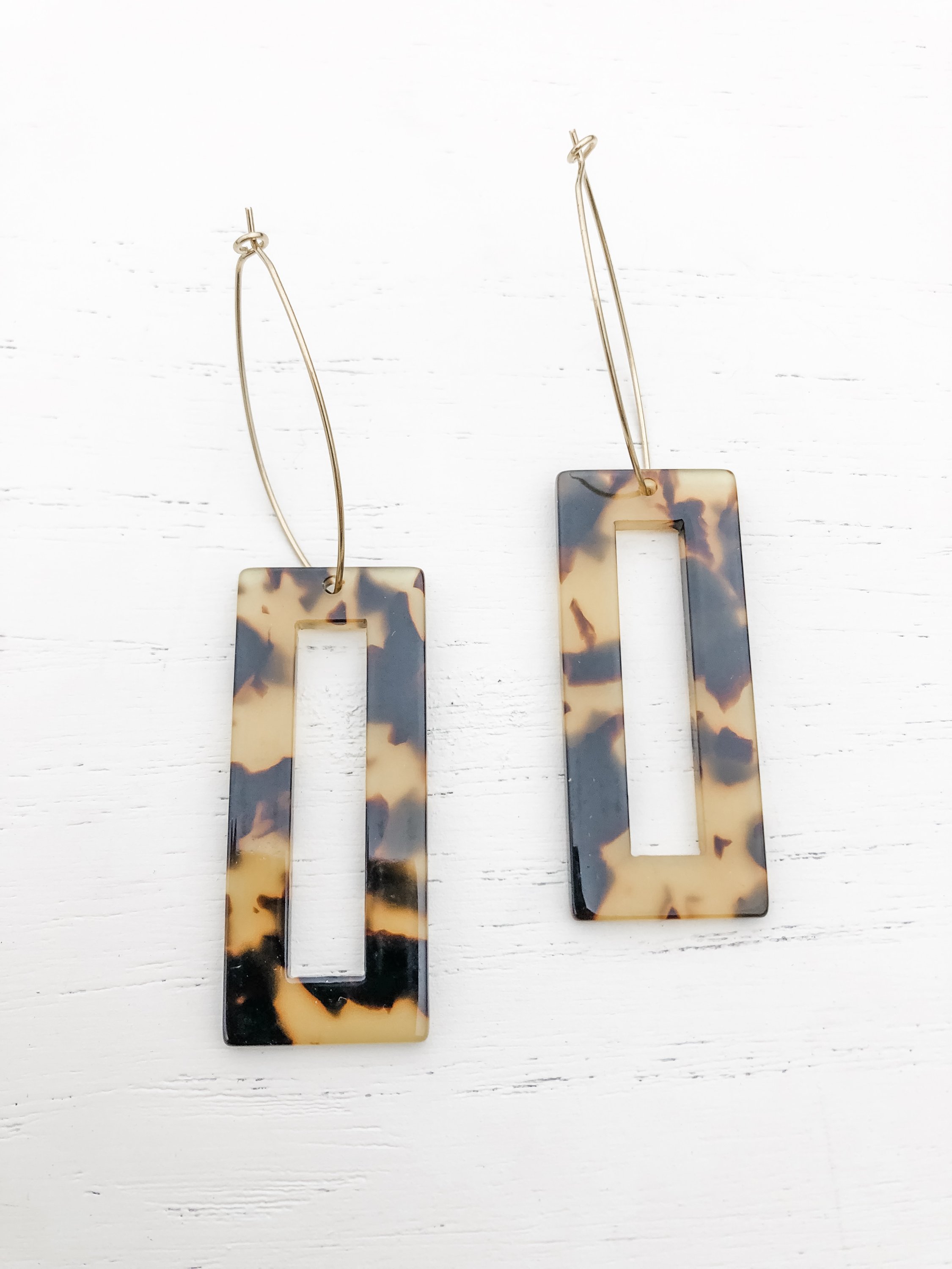 Elegant brass hoop earrings with dark tortoise shell resin detail, measuring approximately 3-1/8 inches in length.