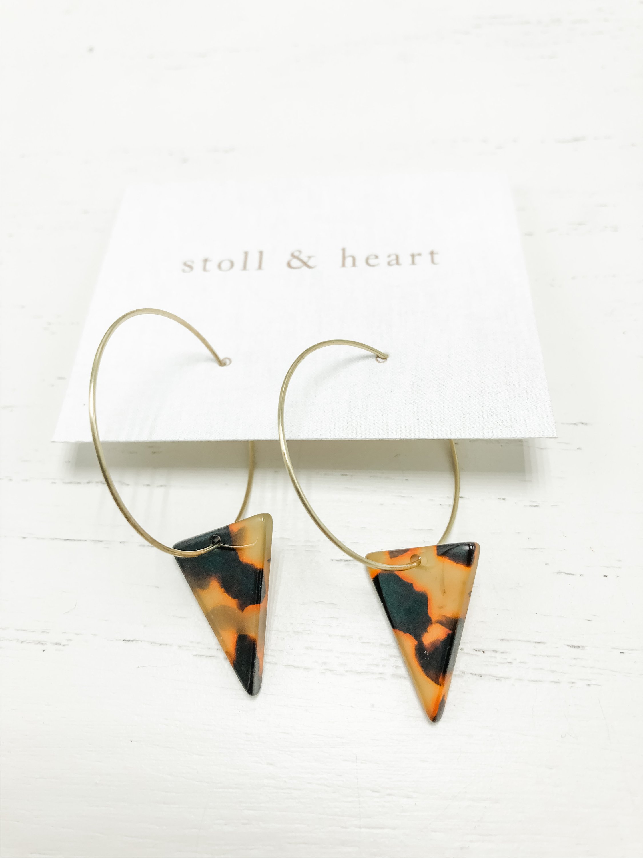 The Marley Dark Tortoise Triangle earrings featuring brass hoops and dark tortoise shell resin detail, measuring approximately 2 inches in length.